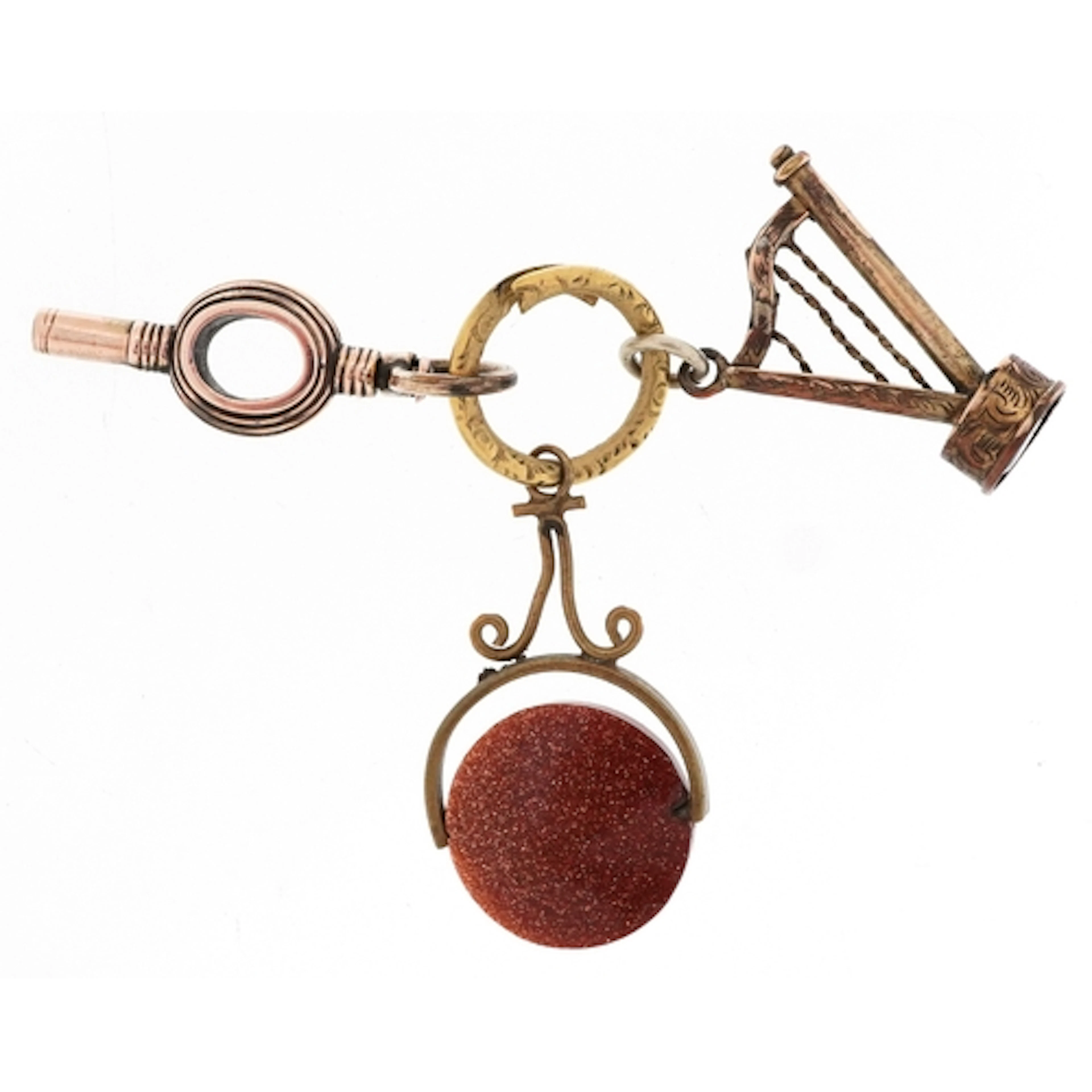 Three antique watch fobs on a Georgian yellow metal spit rin...