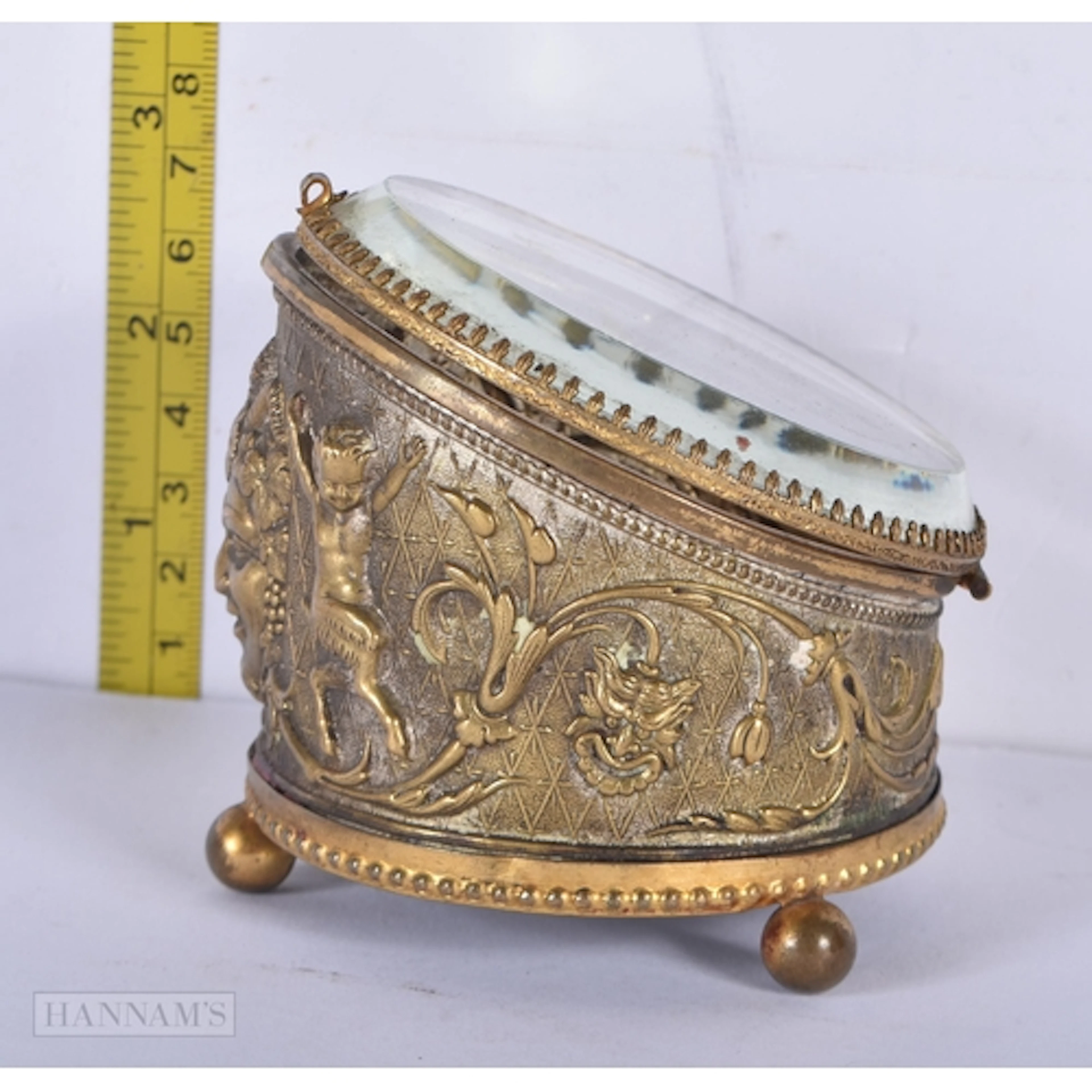 A vintage gilt metal glass topped jewellery casket 7.5 x 8cm