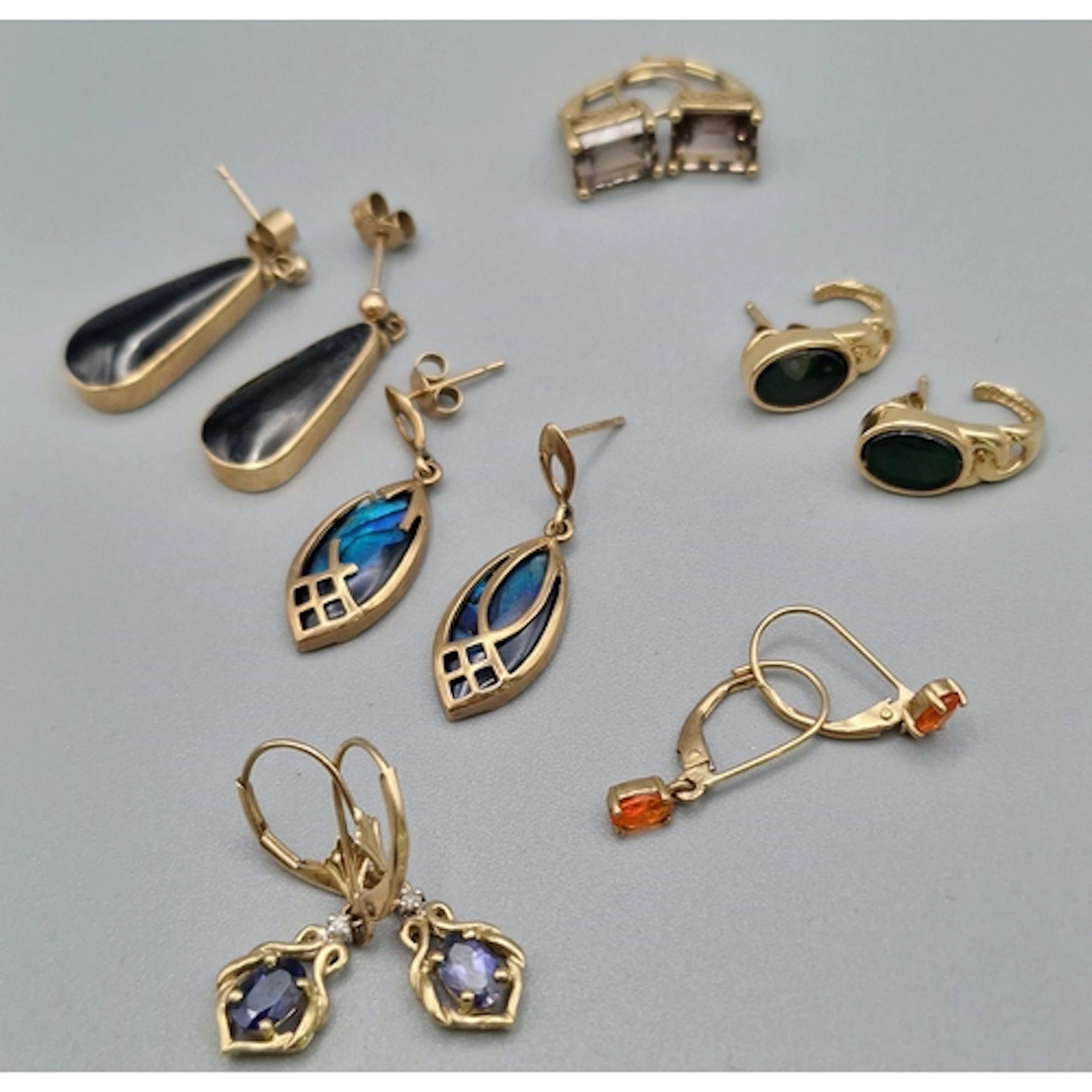 Six pairs of 9ct gold earrings set with semi-precious and ot...