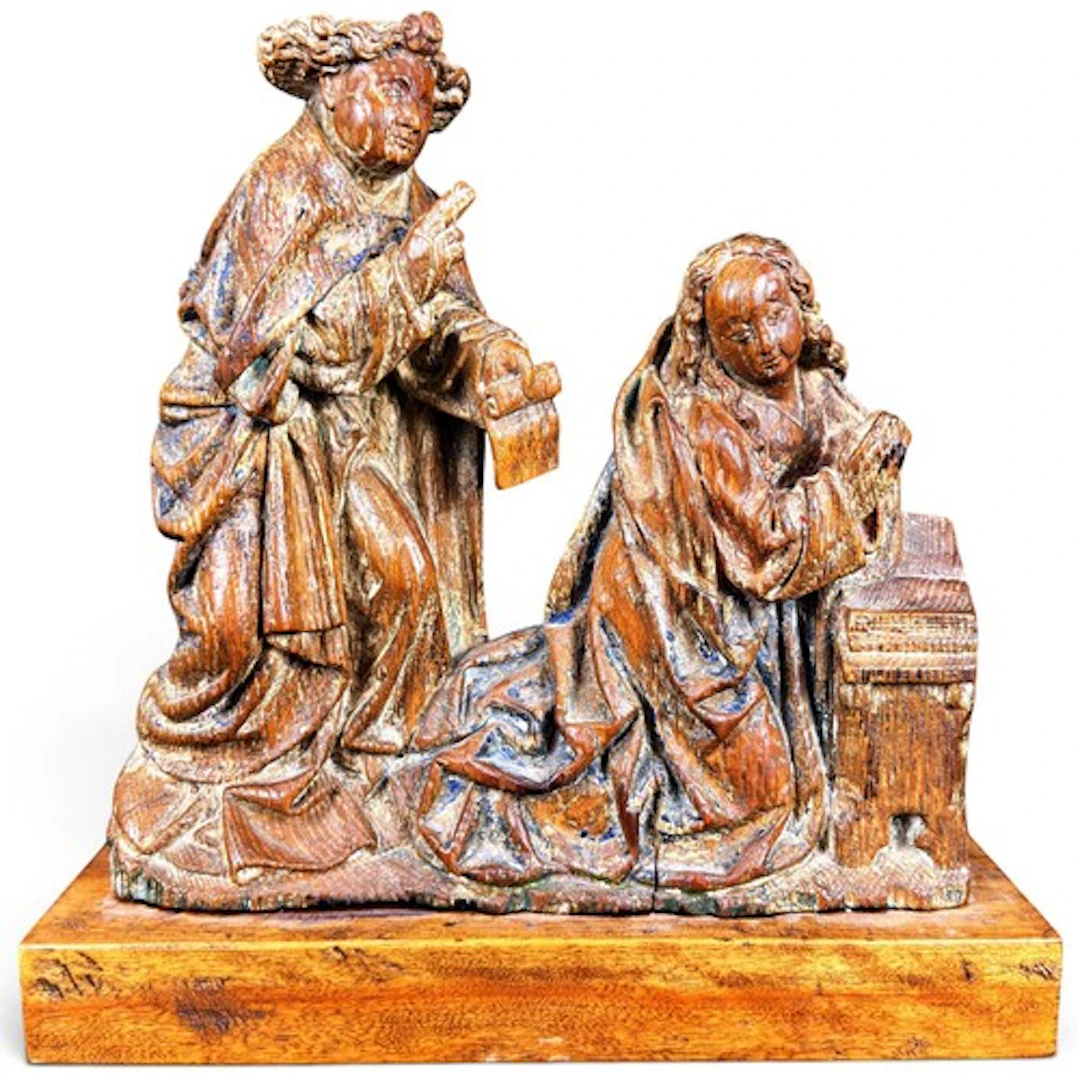 A carved oak relief of the Annunciation, carved in relief wi...