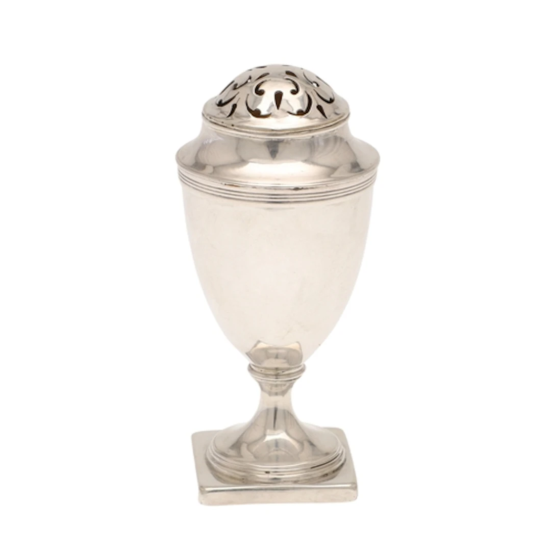 A GEORGE III SILVER MUFFINEER. Of urn form with a pierced to...