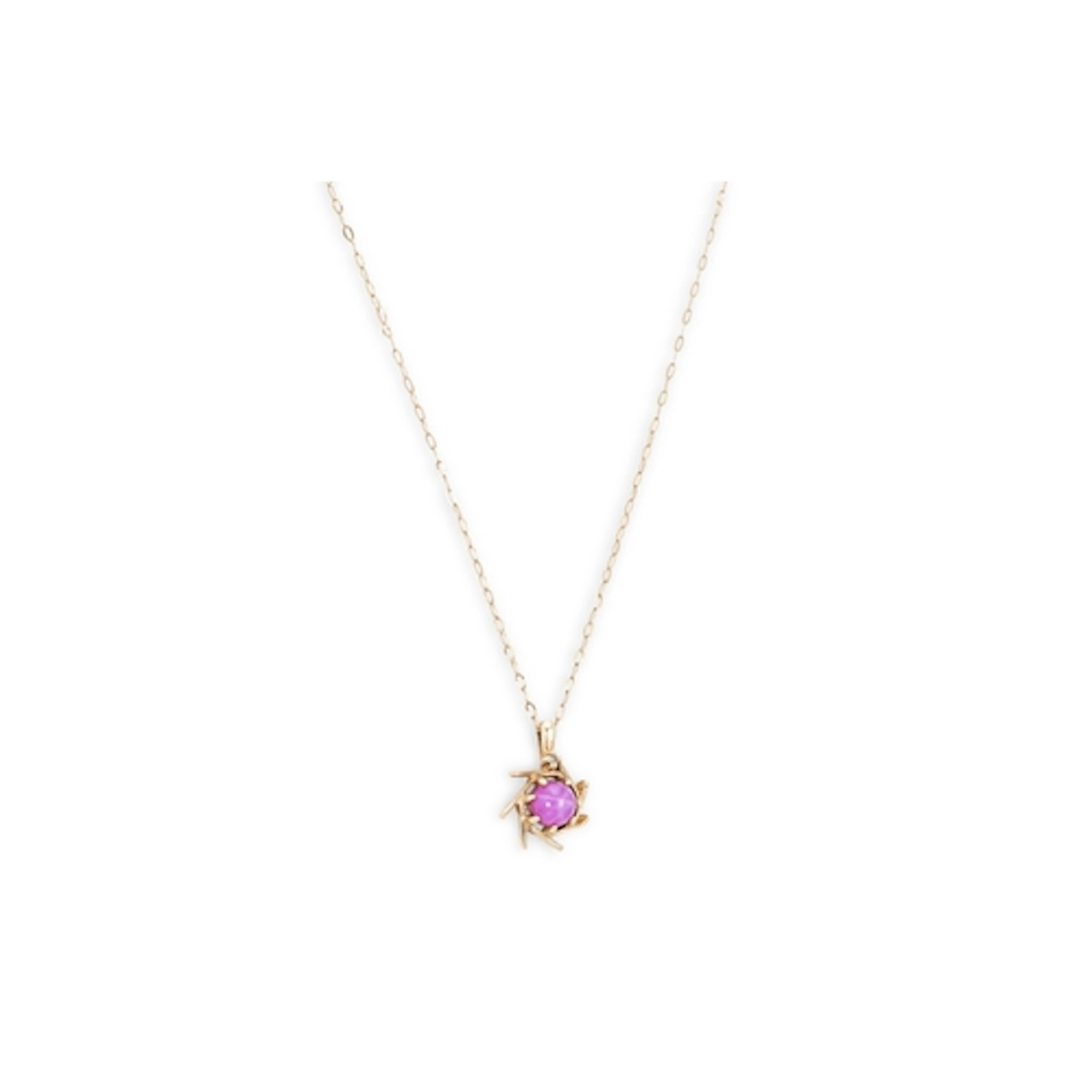 A GOLD AND SYNTHETIC STAR CABOCHON RUBY PENDANT, the pendant...