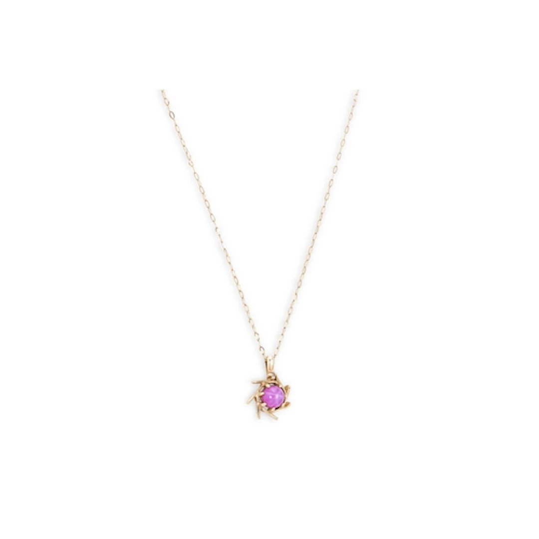 A GOLD AND SYNTHETIC STAR CABOCHON RUBY PENDANT, the pendant...