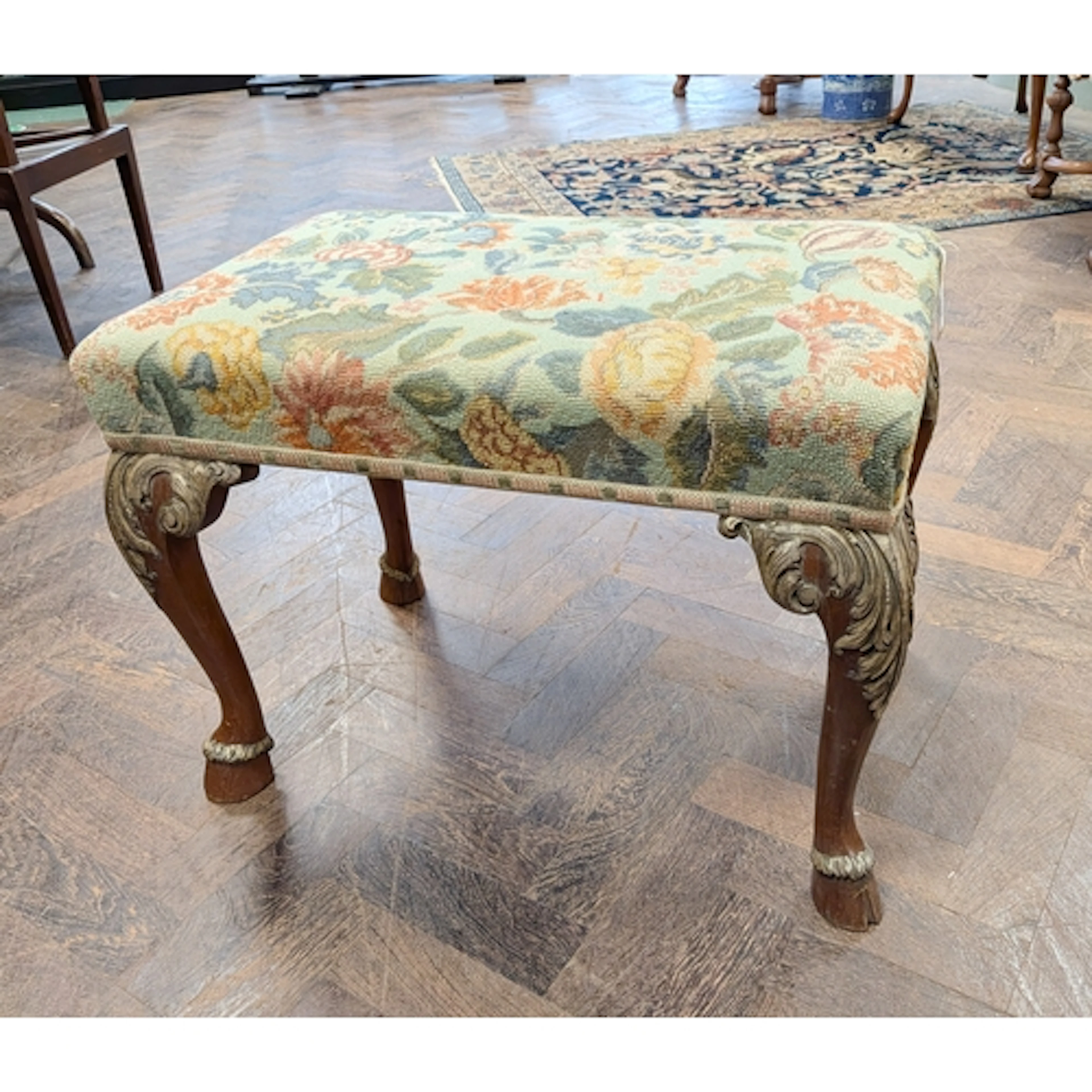 A William and Mary style parcel gilt cabriole leg footstool,...