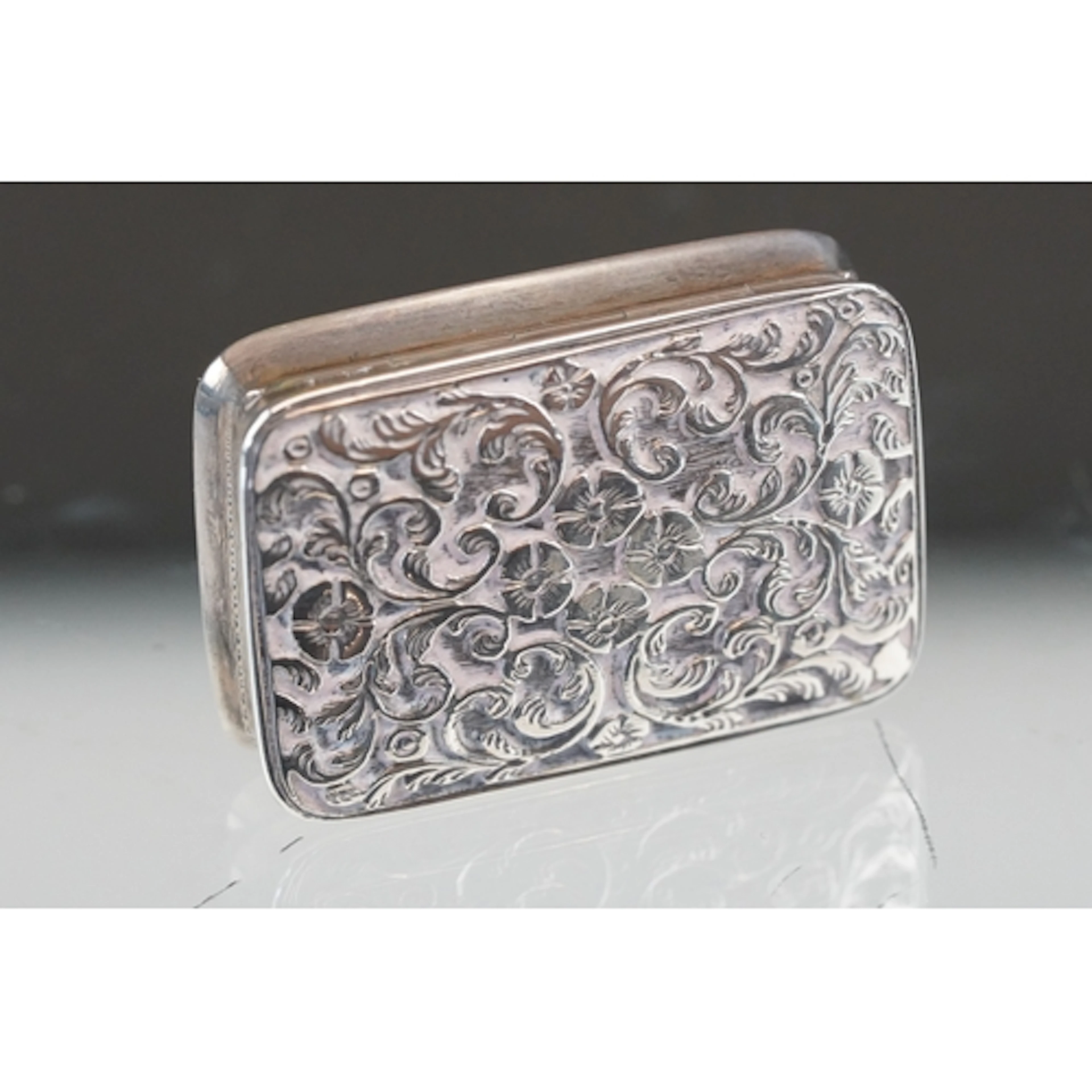 Georgian silver vinaigrette, the lid repousse decorated with...