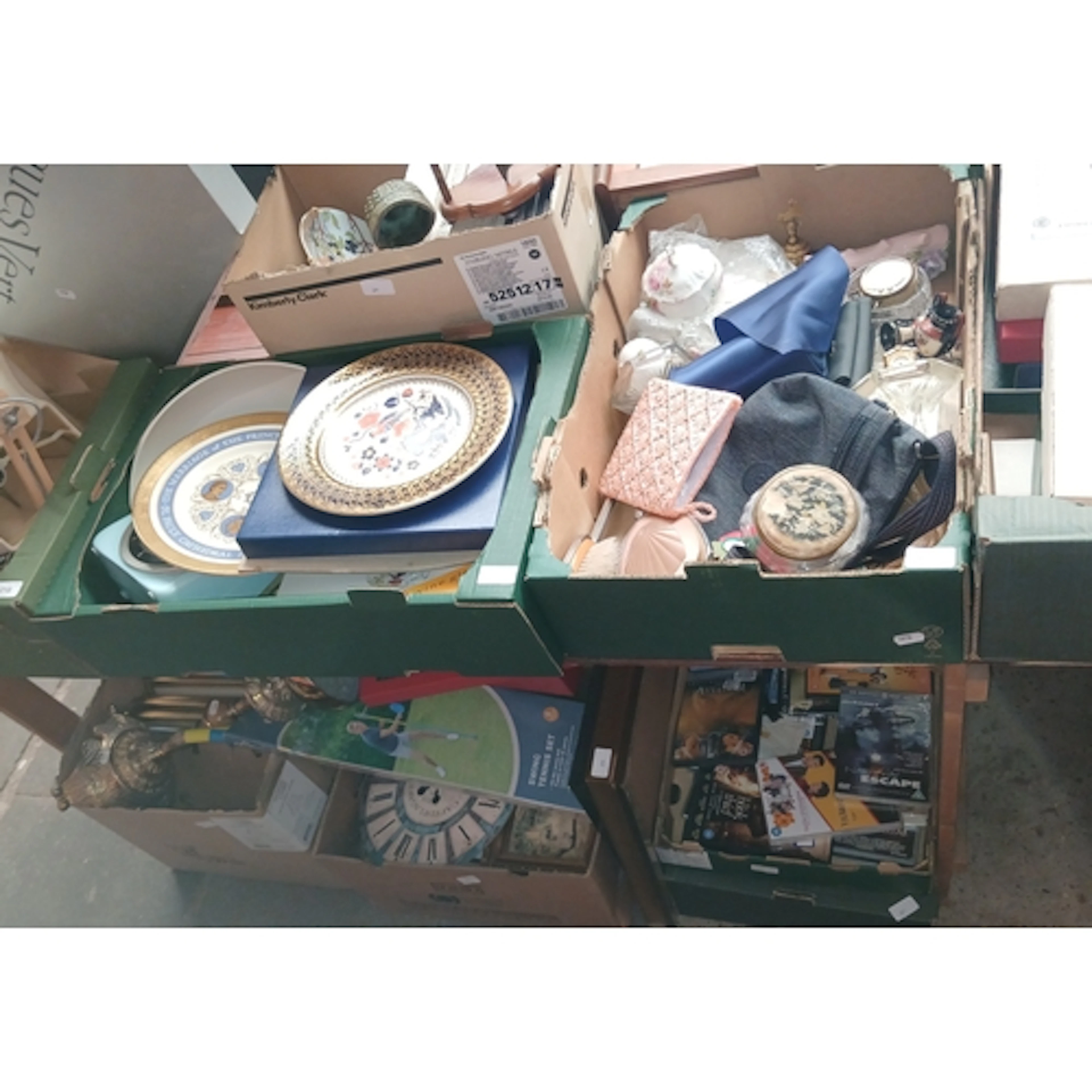 A table top and below, appx 12 boxes, of mixed items includi...