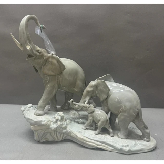 A Lladro figure of a group of elephants. As Found. Trunk pre...