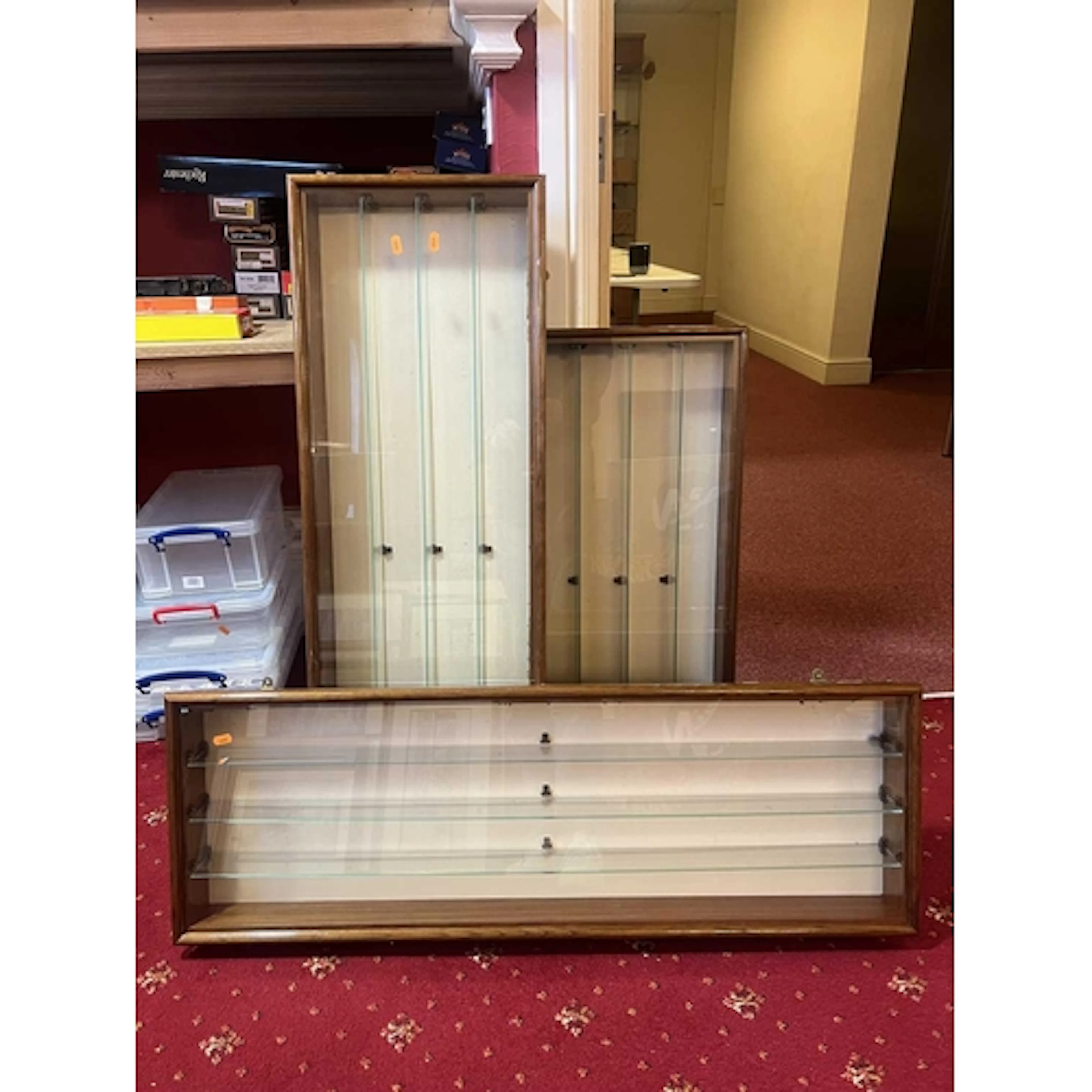 THREE WALL MOUNTED DISPLAY CASES, each wooden with glass fro...