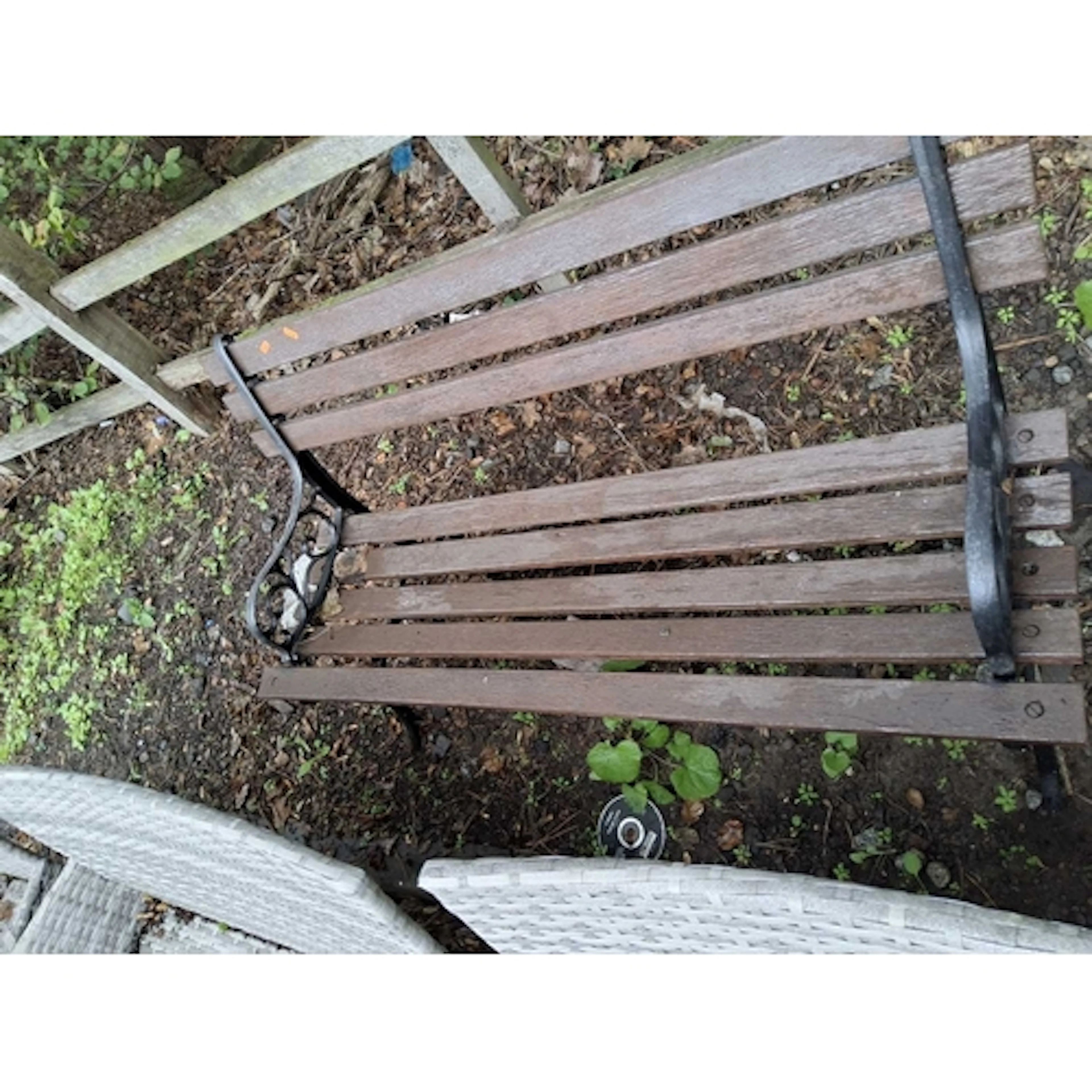 A CAST IRON ENDED GARDEN BENCH with a wooden slatted seat an...