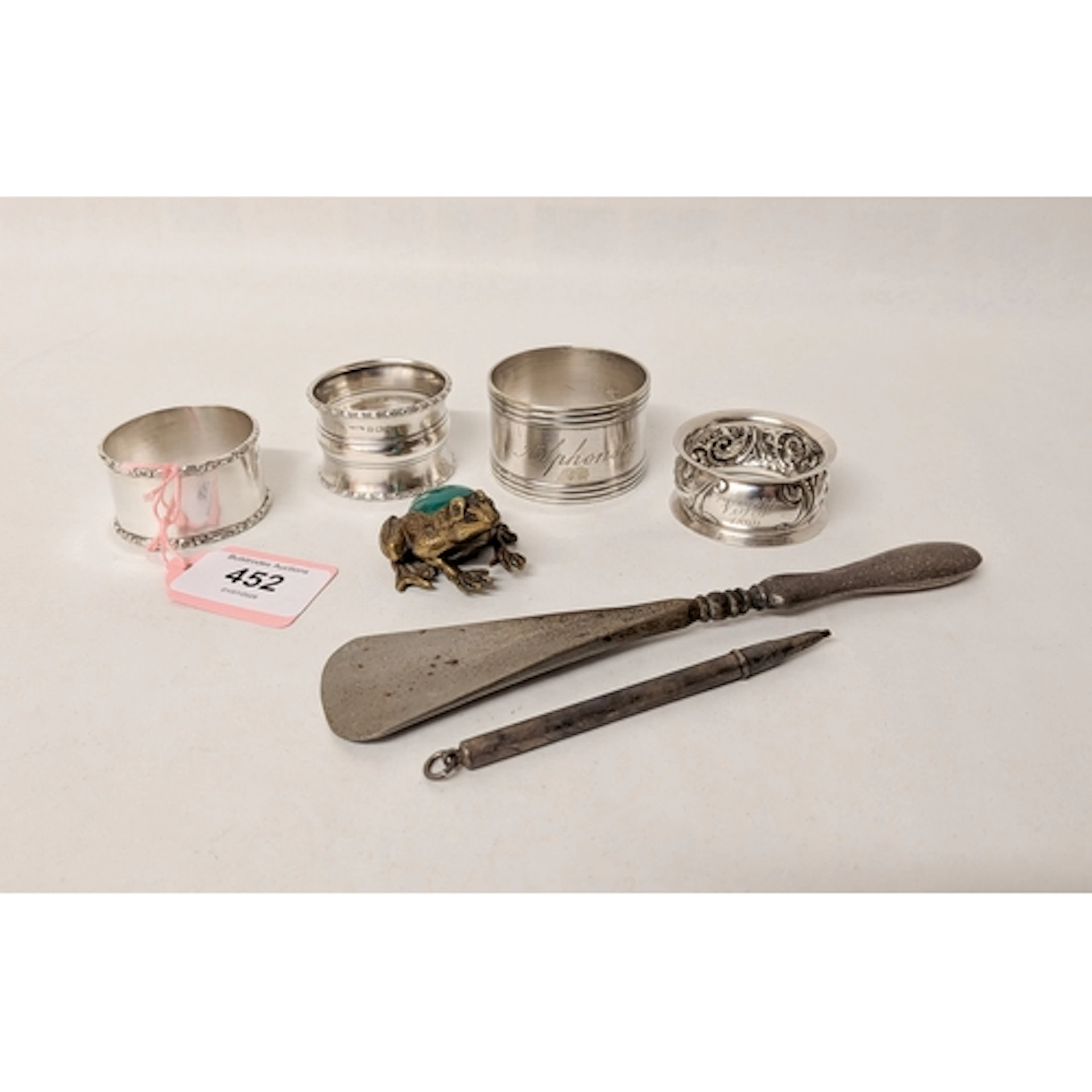 Three silver napkin rings, silver propelling pencil, Christo...