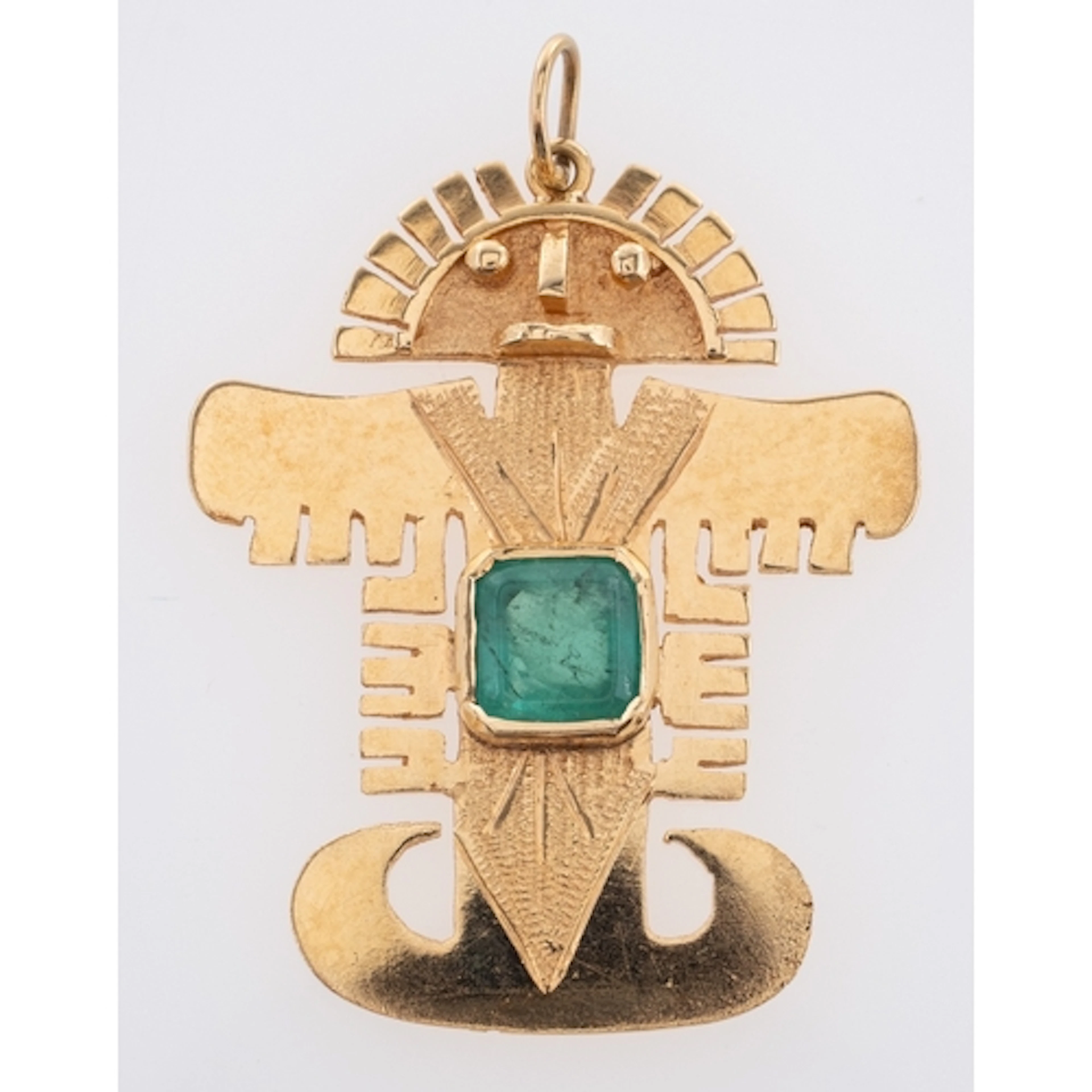 A Contemporary Emerald Aztec Pendant, collet set at the cen...