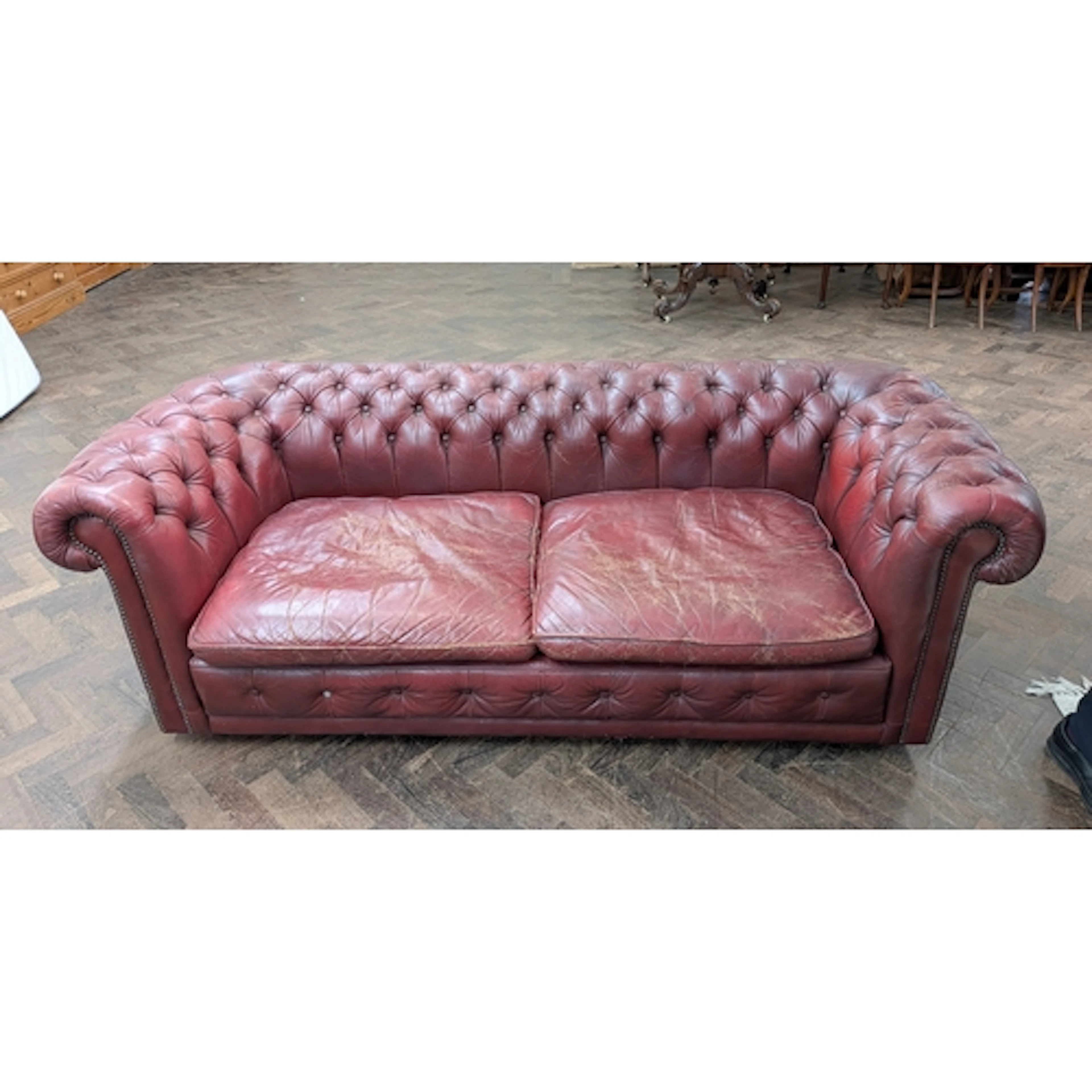 An Oxblood antique Chesterfield leather two seater sofa