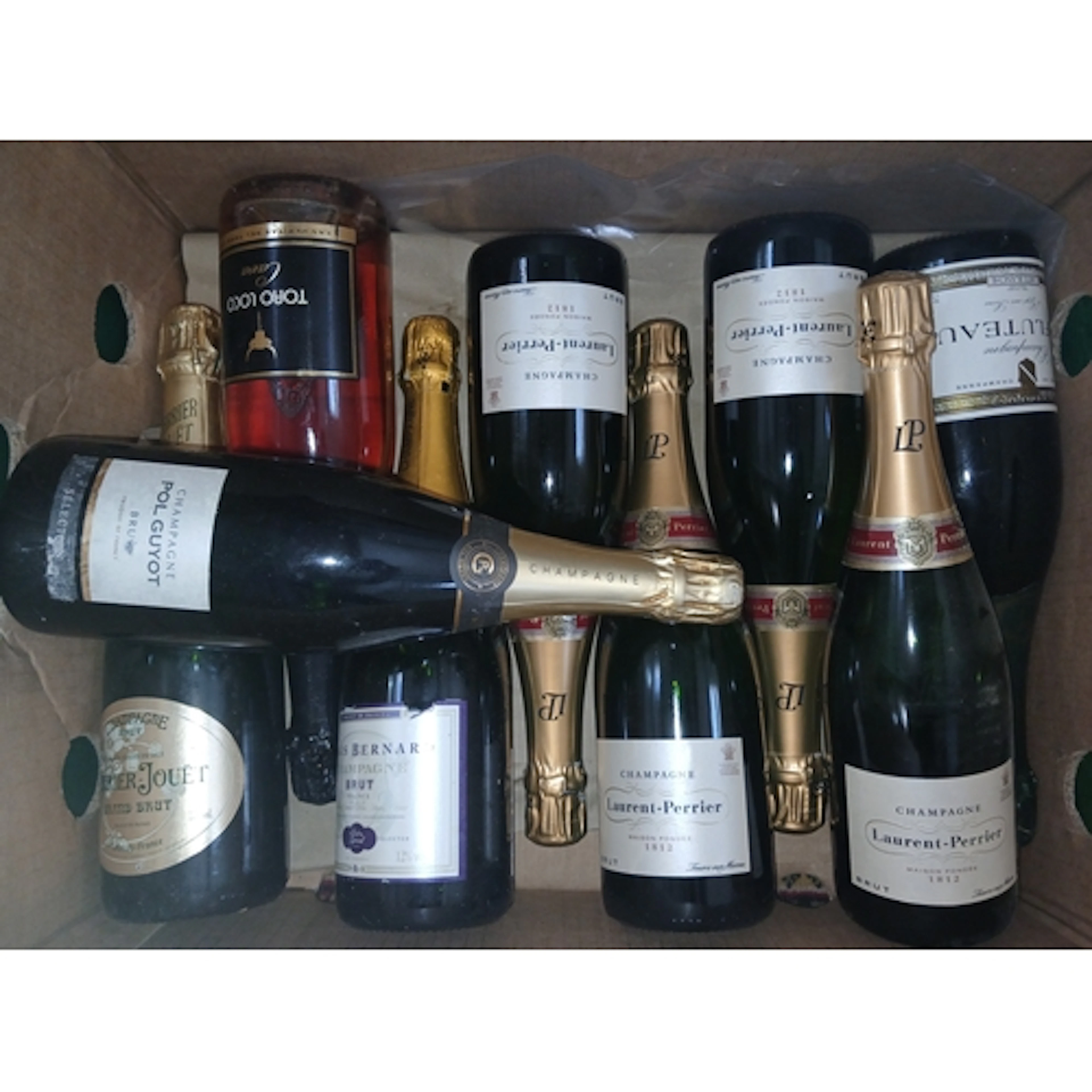 Nine bottles of assorted sparkling wine.