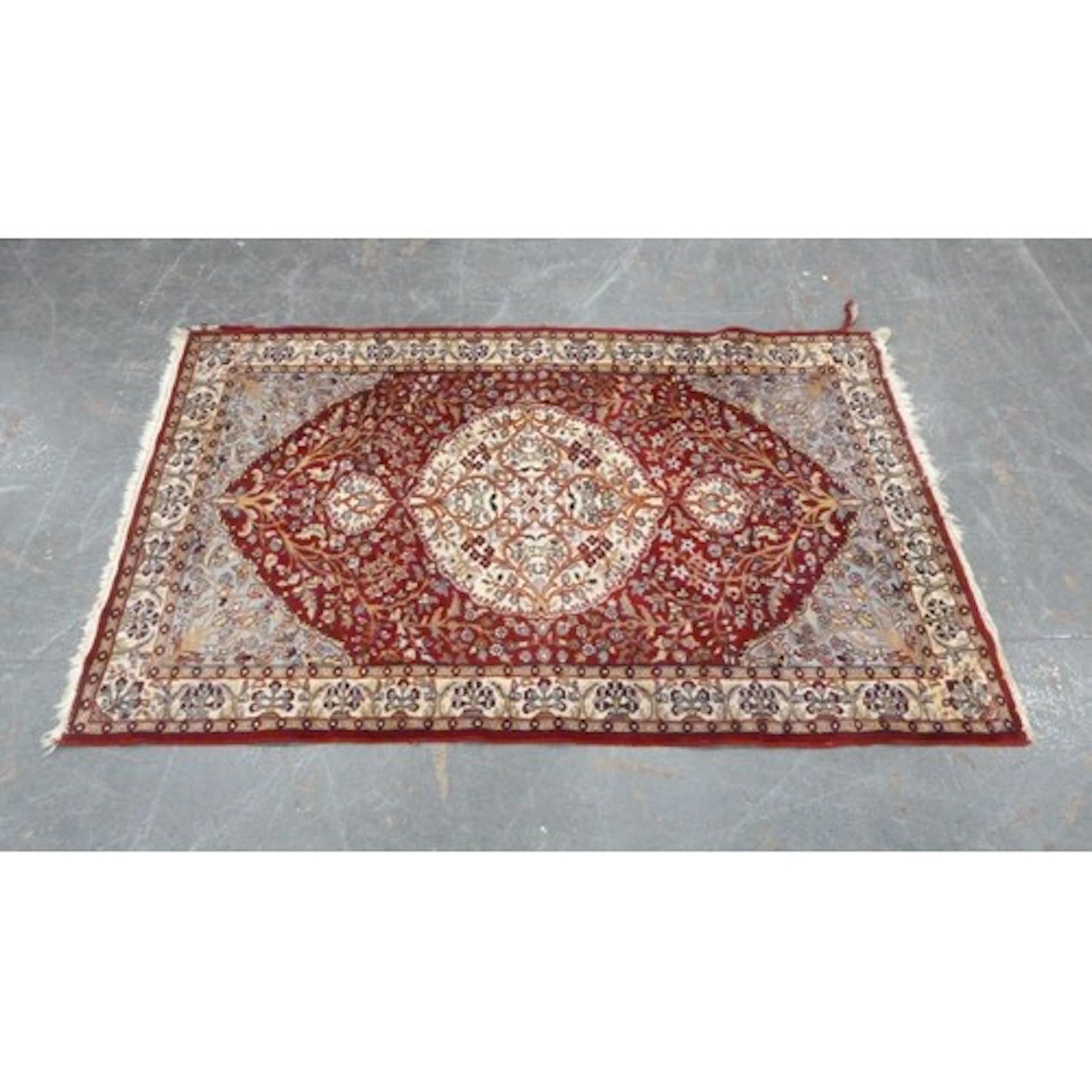 Persian Kashan style hand knotted rug on red ground.