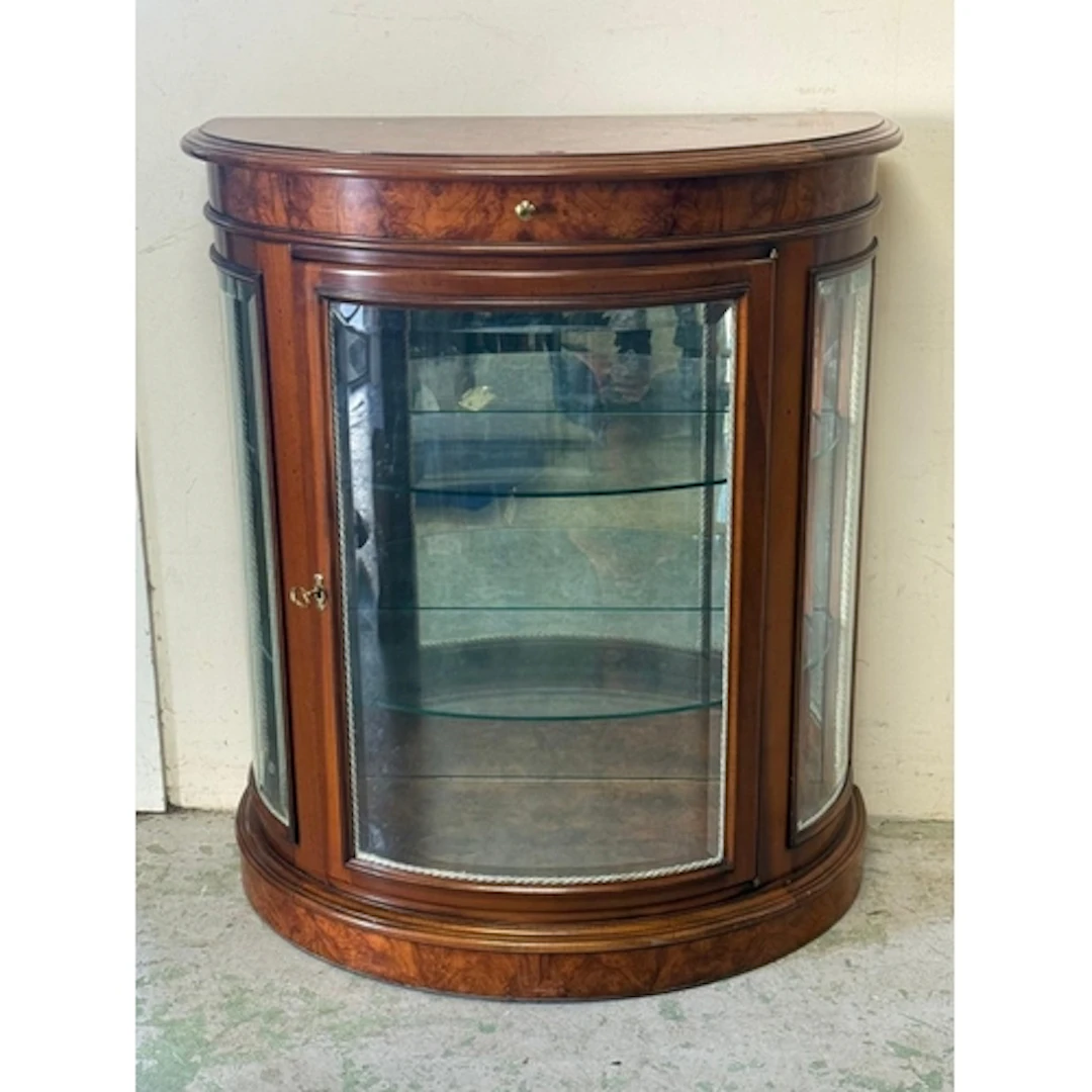 A walnut veneer Demi-lune glazed display cabinet