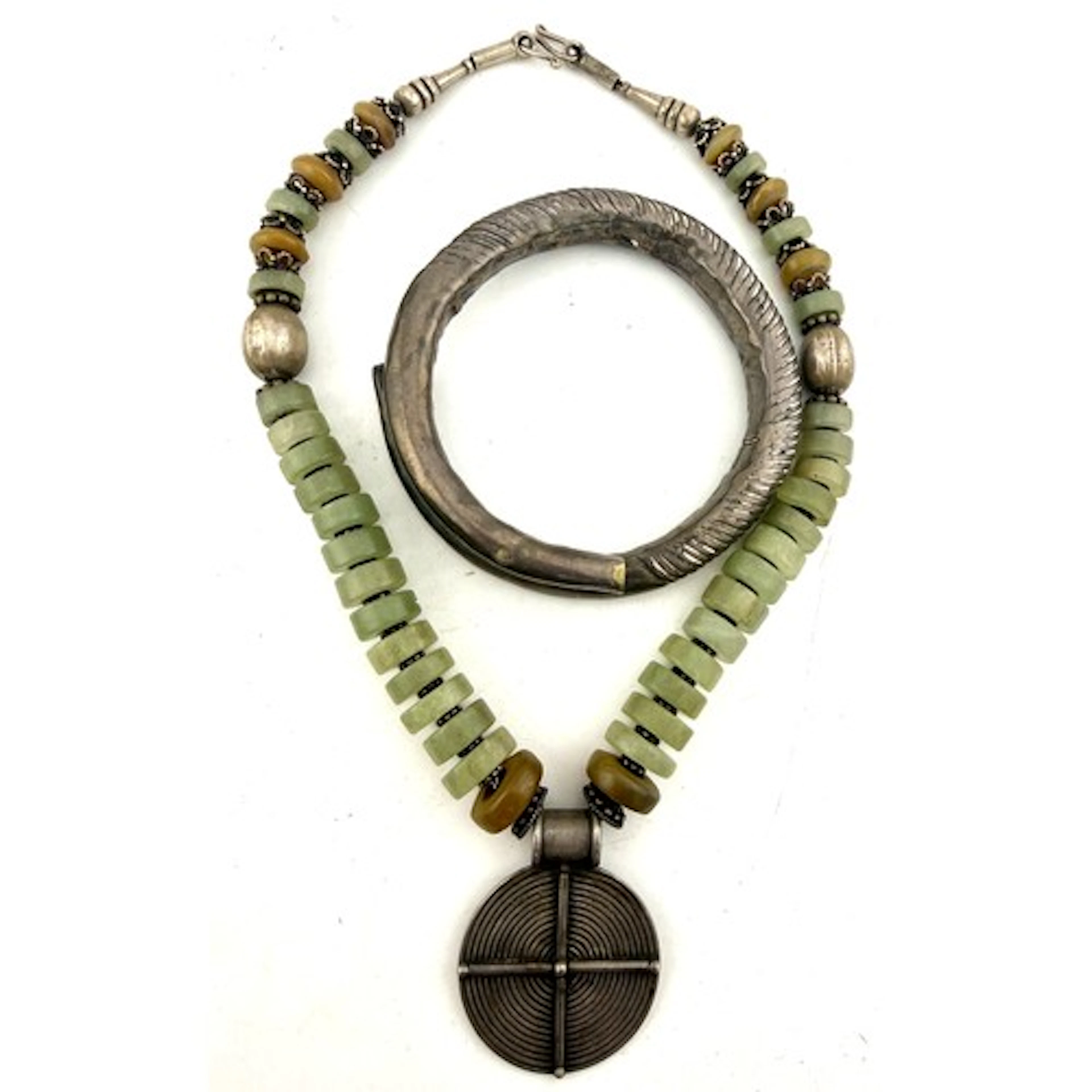 A vintage tribal necklace comprising white metal and green h...