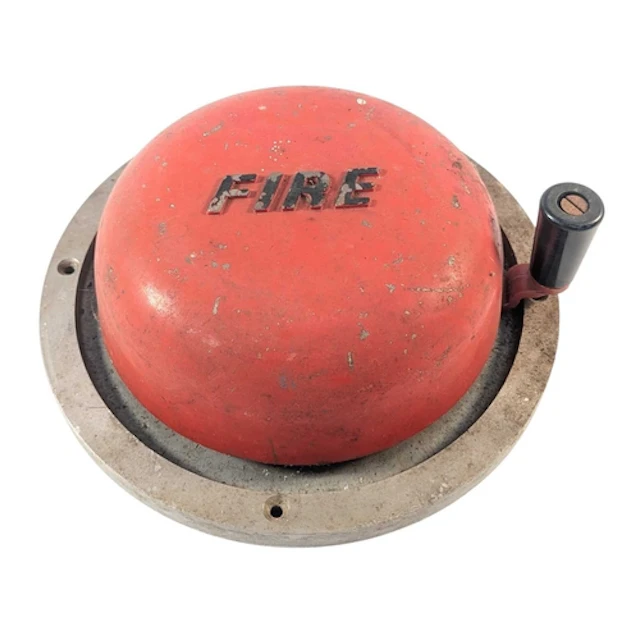 A vintage wall mounted manual rotary fire alarm bell. Cast m...