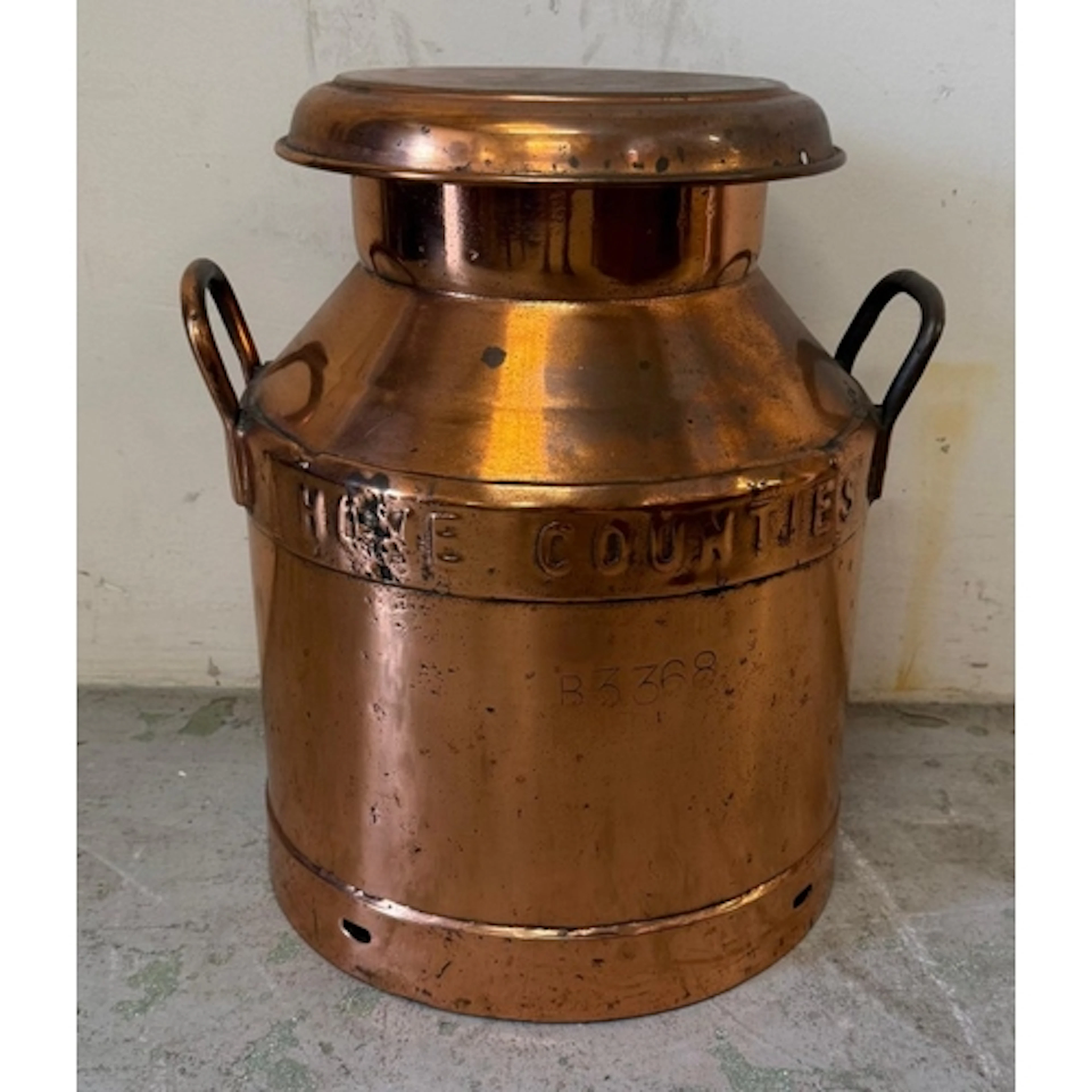A vintage copper home counties twin-handled milk churn...