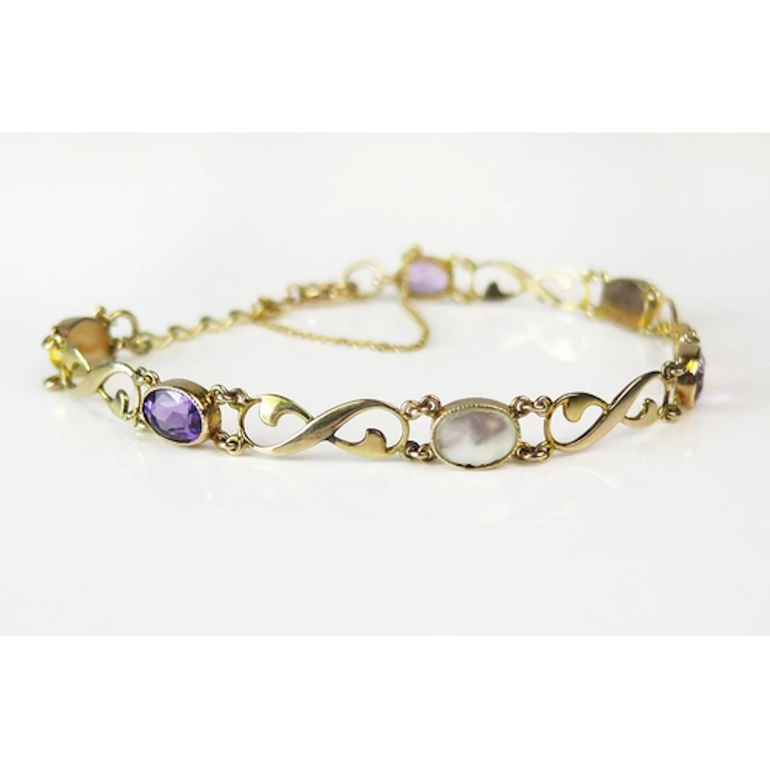 An amethyst and blister pearl bracelet in a 9ct yellow gold ...