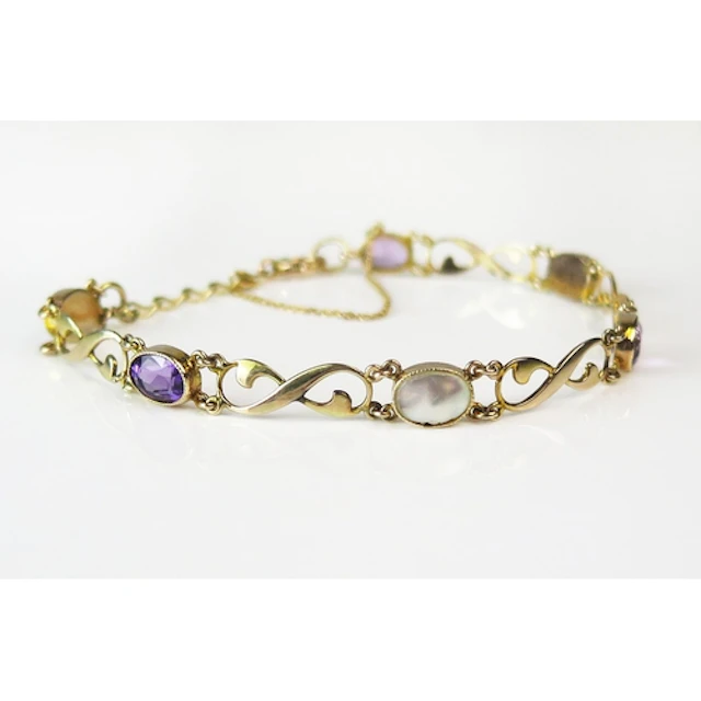 An amethyst and blister pearl bracelet in a 9ct yellow gold ...