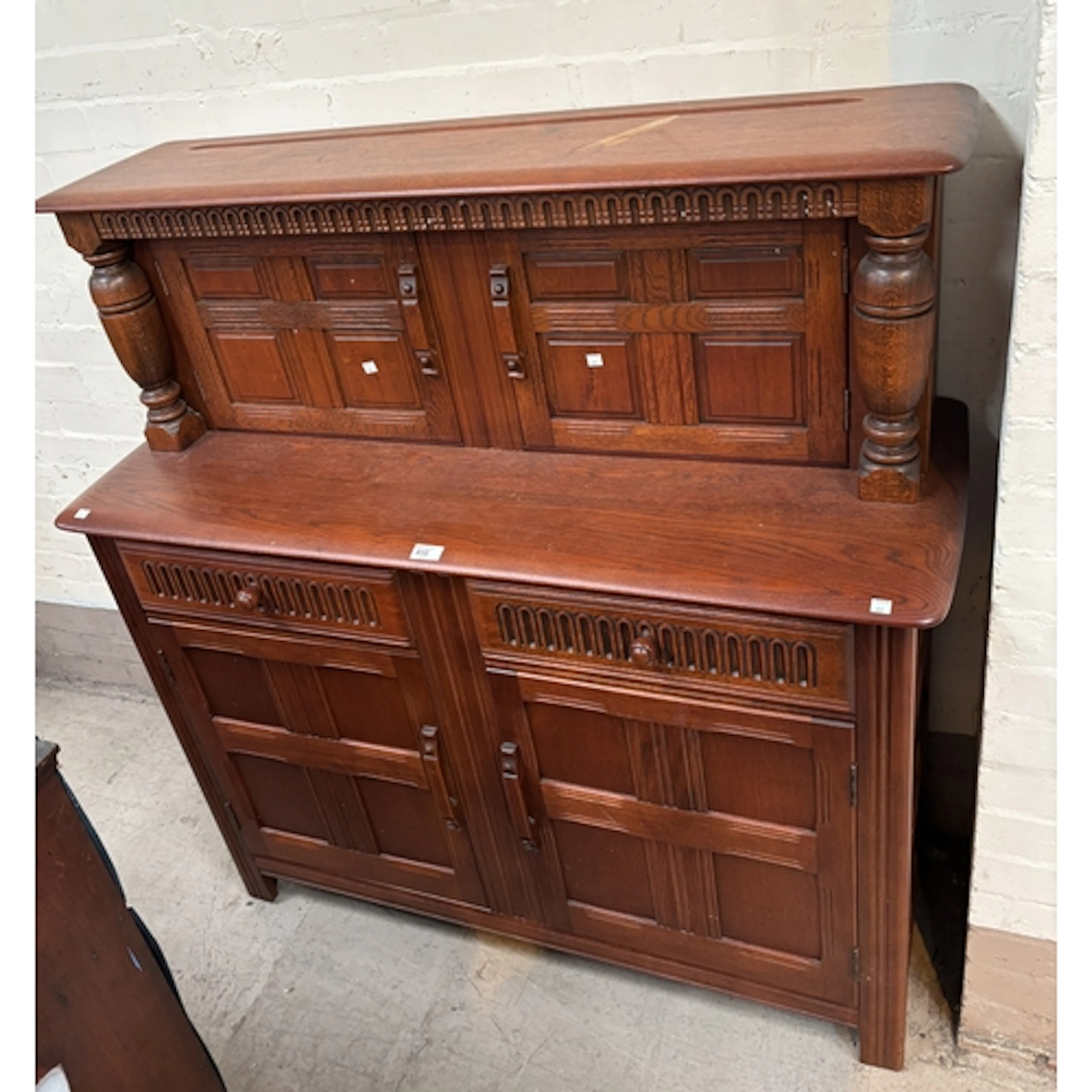 A modern oak buffet sideboard with cupboards above and below...