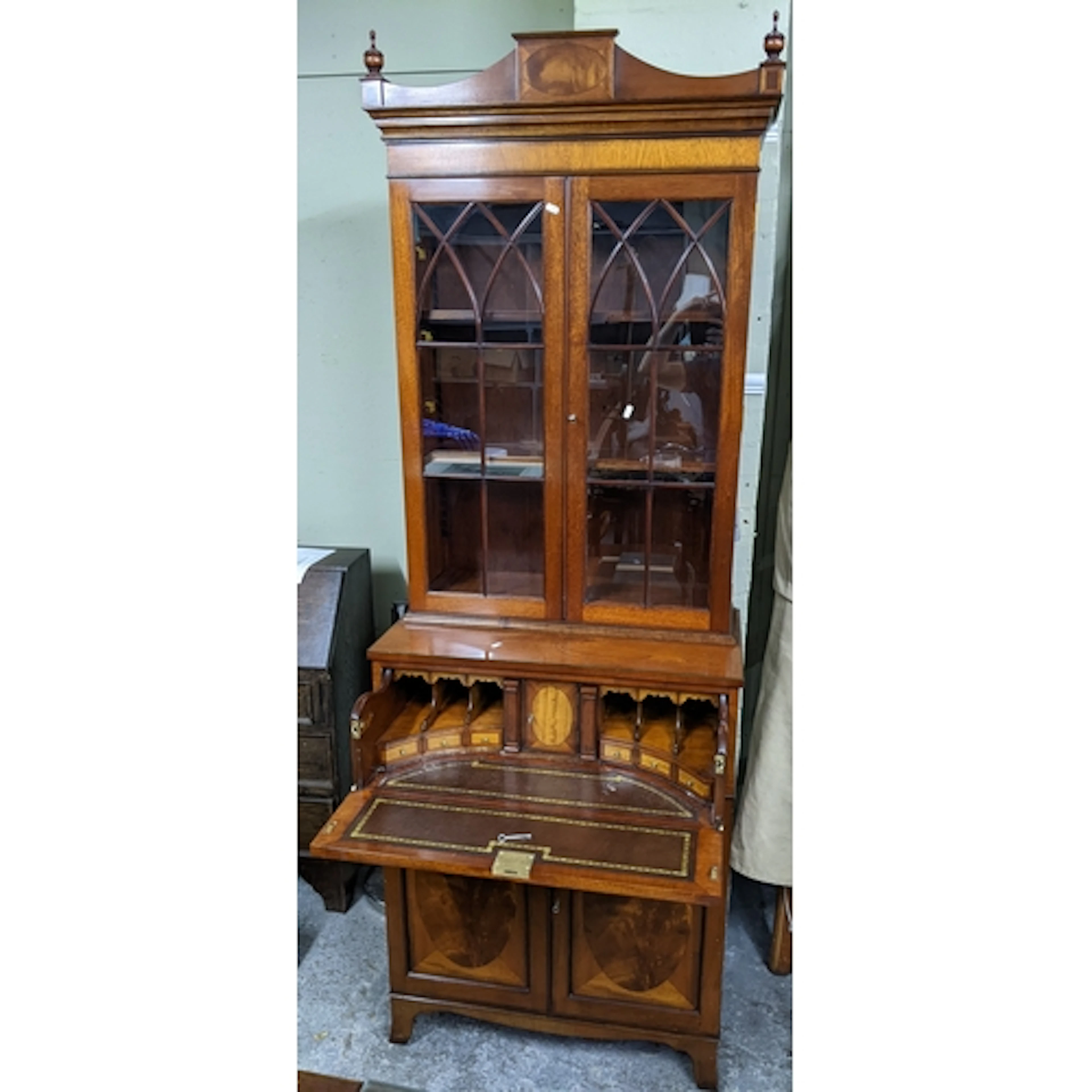 A reproduction mahogany secretaire bookcase having twin glaz...