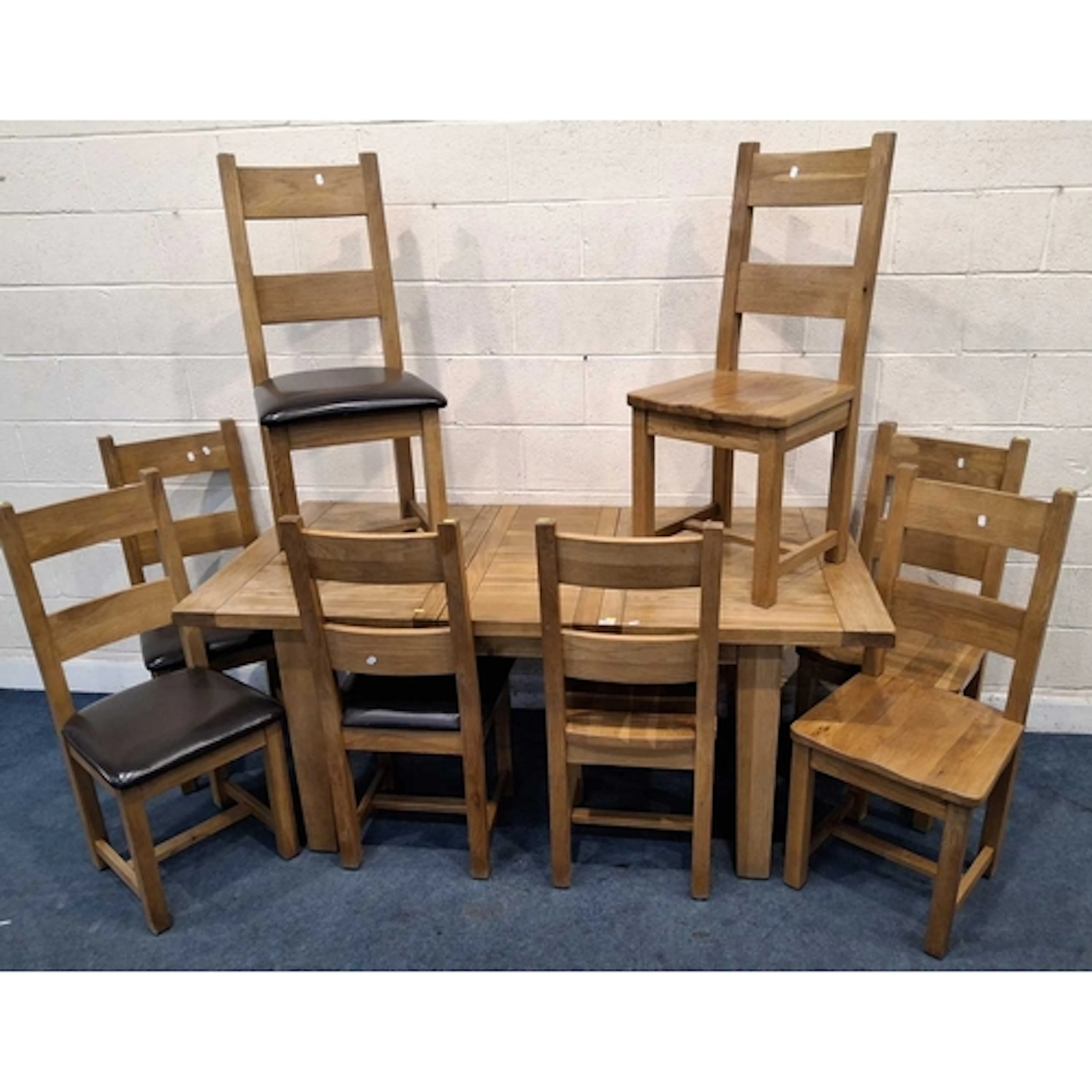 A MODERN LIGHT OAK EXTENDING DINING TABLE, with a single fol...