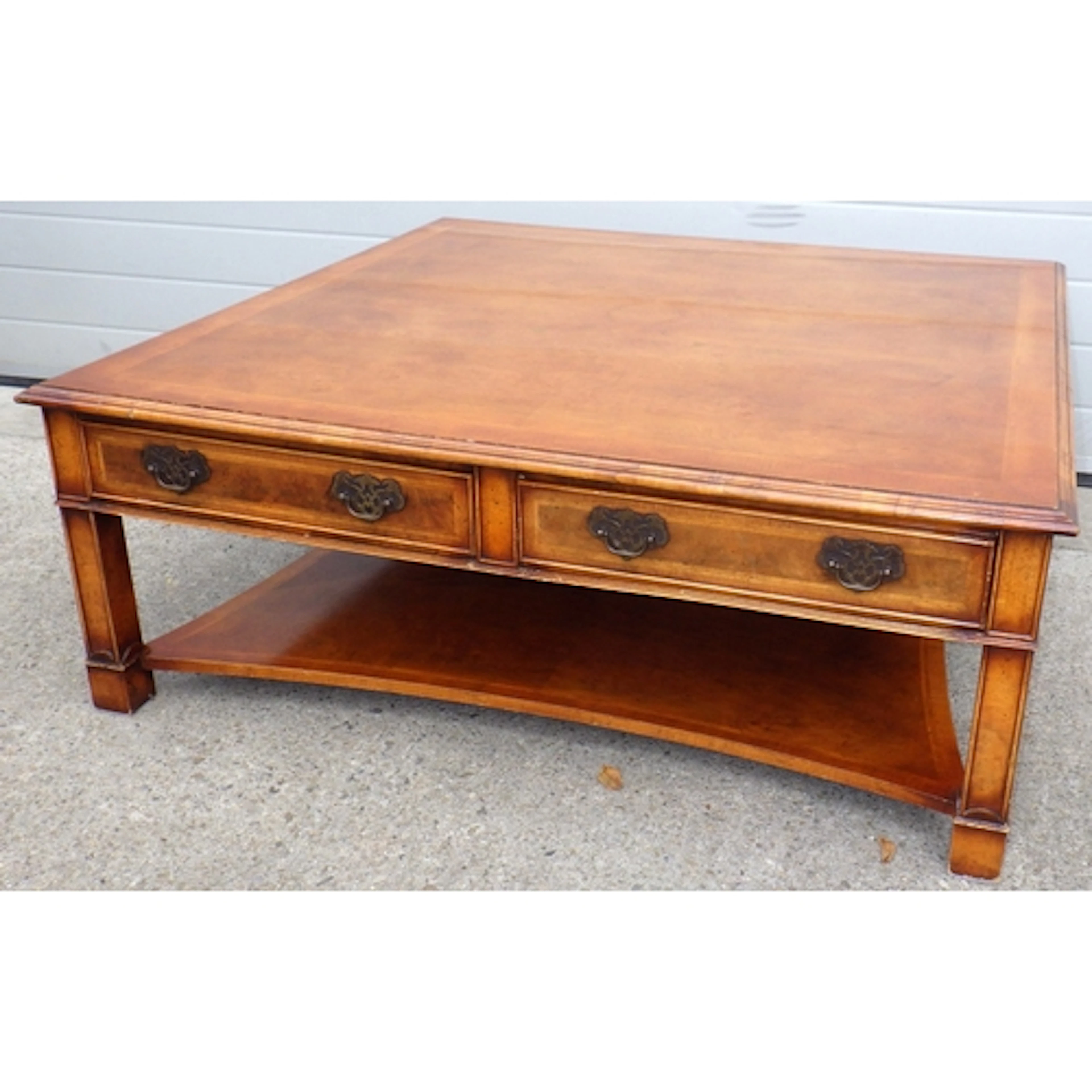 A large reproduction yew square coffee table, missing some m...