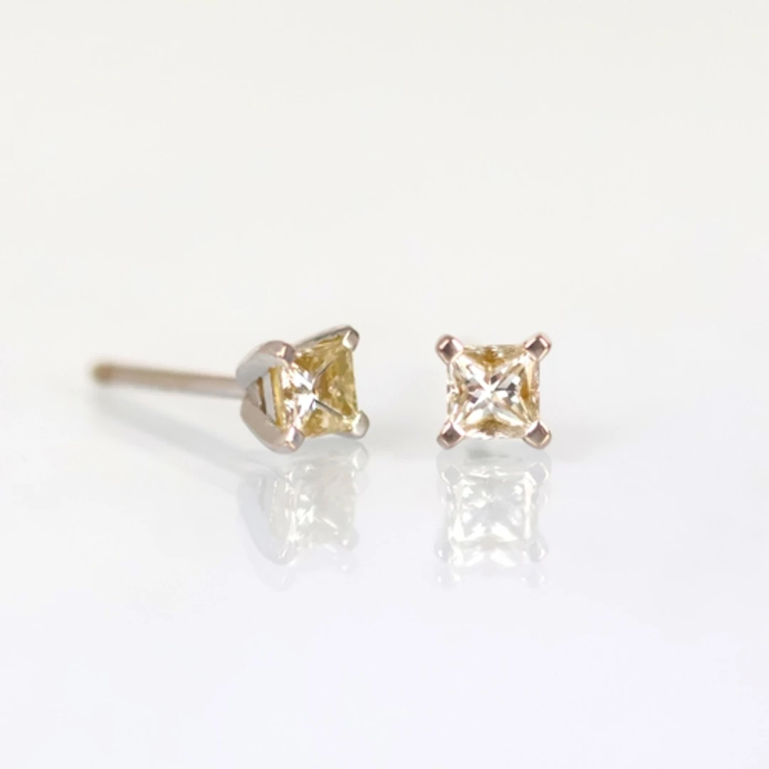 A pair of 18ct white gold diamond earrings, the princess cut...