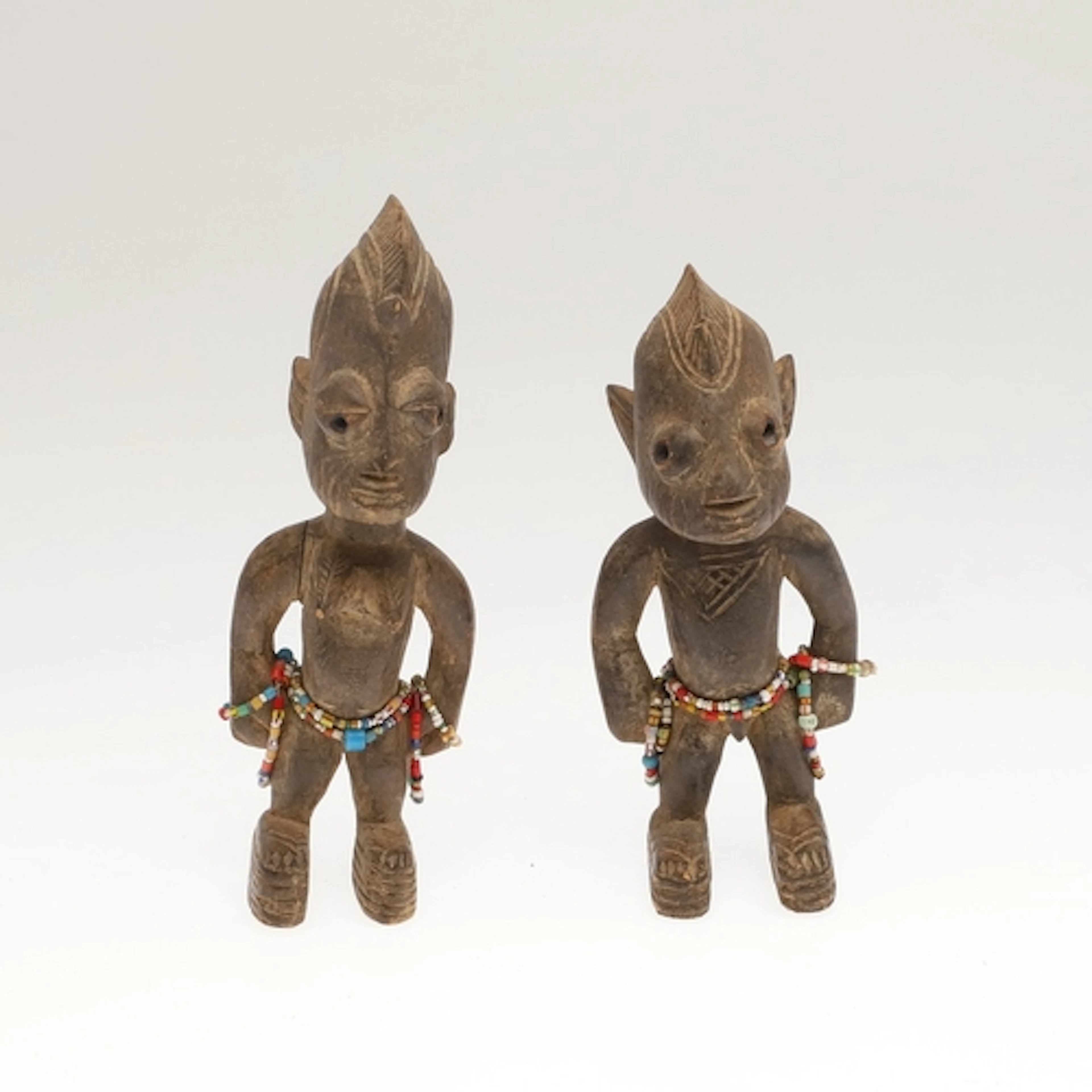 A PAIR OF AFRICAN YORUBA 'ERE IBEJI' TWIN FIGURES. A pair of...