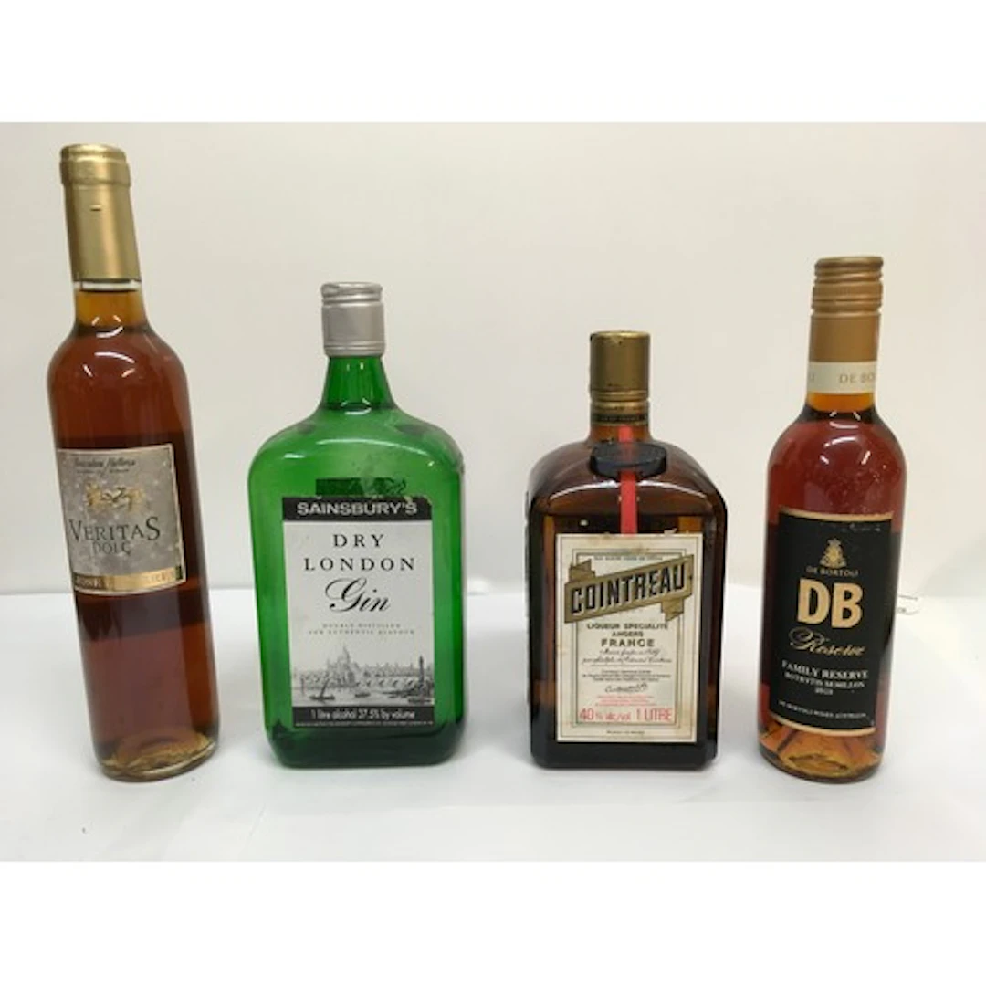 Four bottles of alcohol comprising Cointreau, dry gin, Verit...