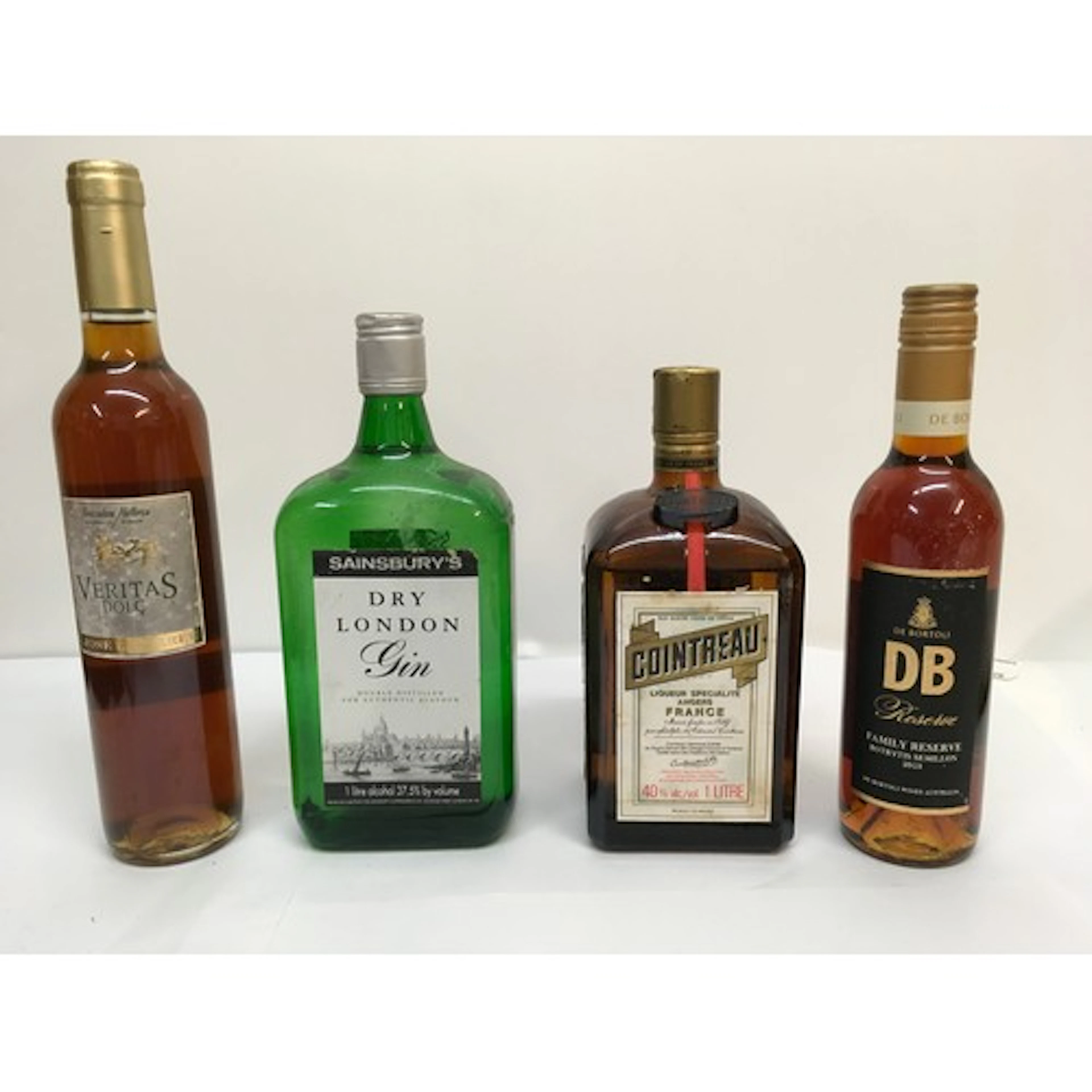 Four bottles of alcohol comprising Cointreau, dry gin, Verit...
