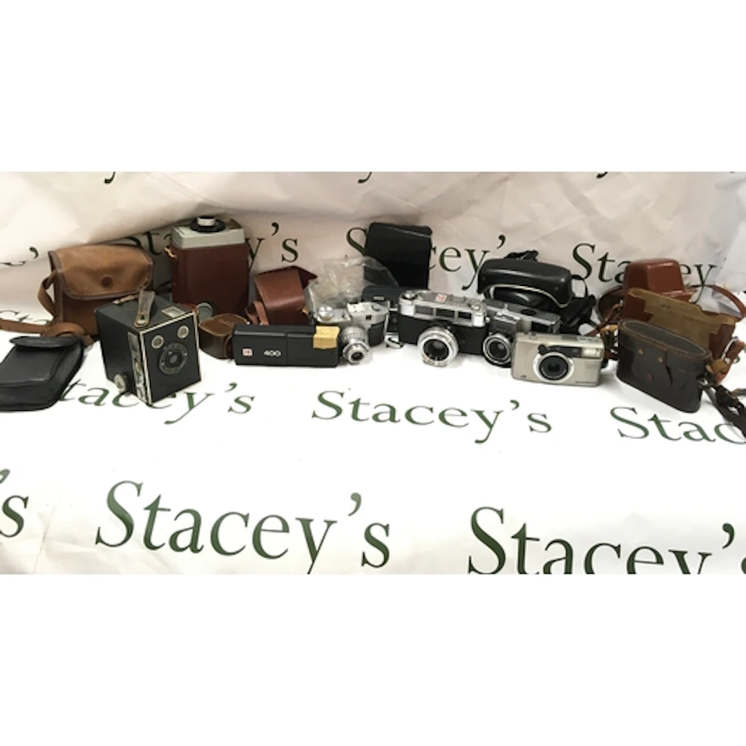 A collection of cameras and cases and other camera accessori...