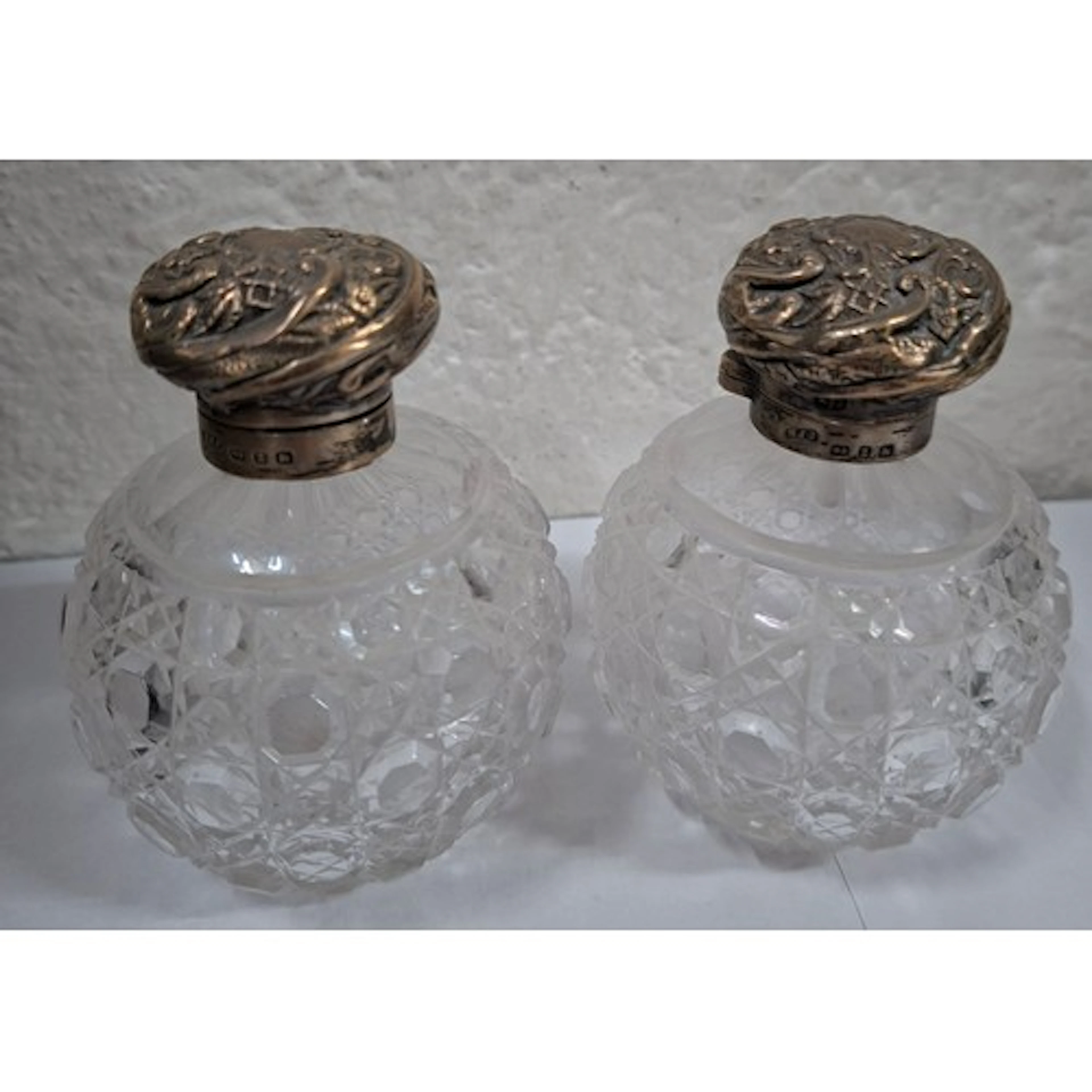 Two silver topped glass dressing table scent bottles, with i...