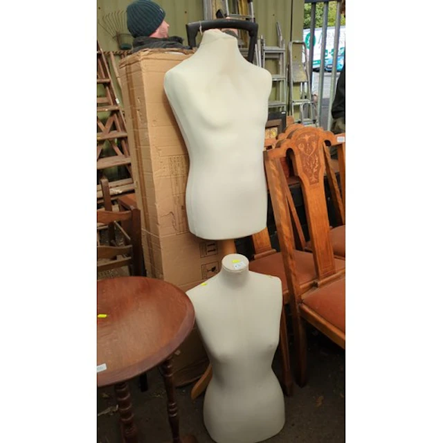 A pair of cream fabric-covered female torso display mannequi...