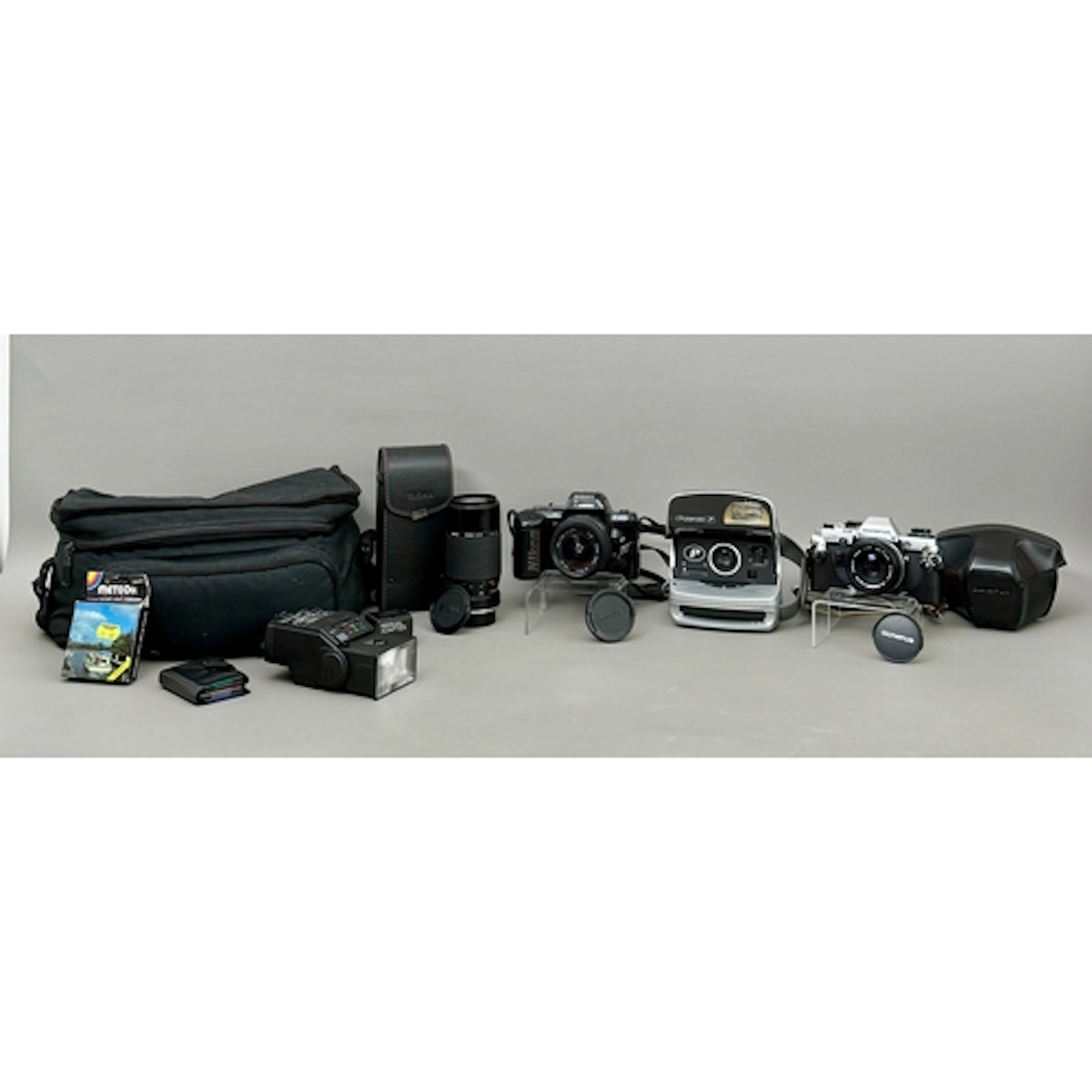 Three vintage cameras, comprising - 1. An Olympus OM10 35m...