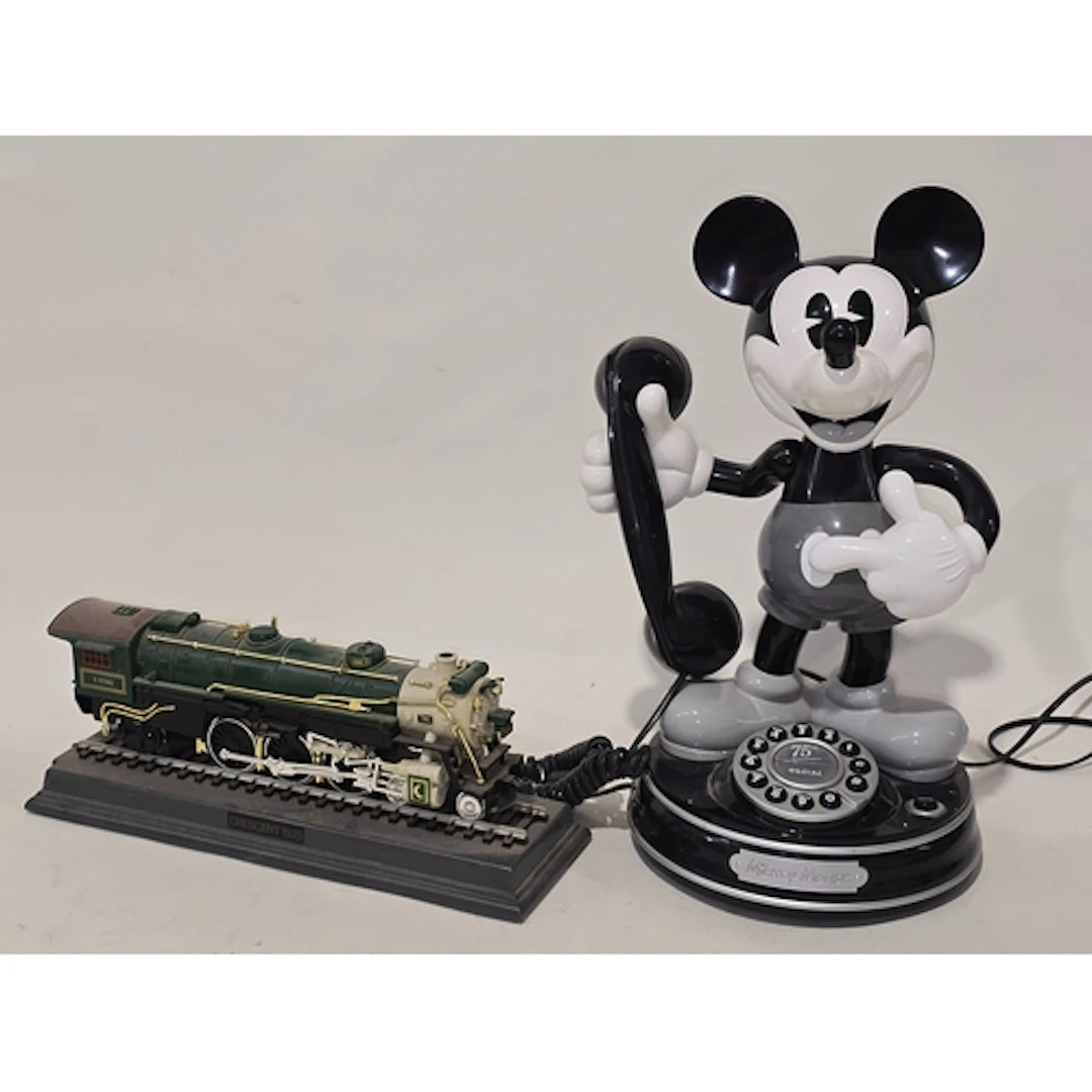 A vintage Mickey Mouse novelty telephone together with anoth...