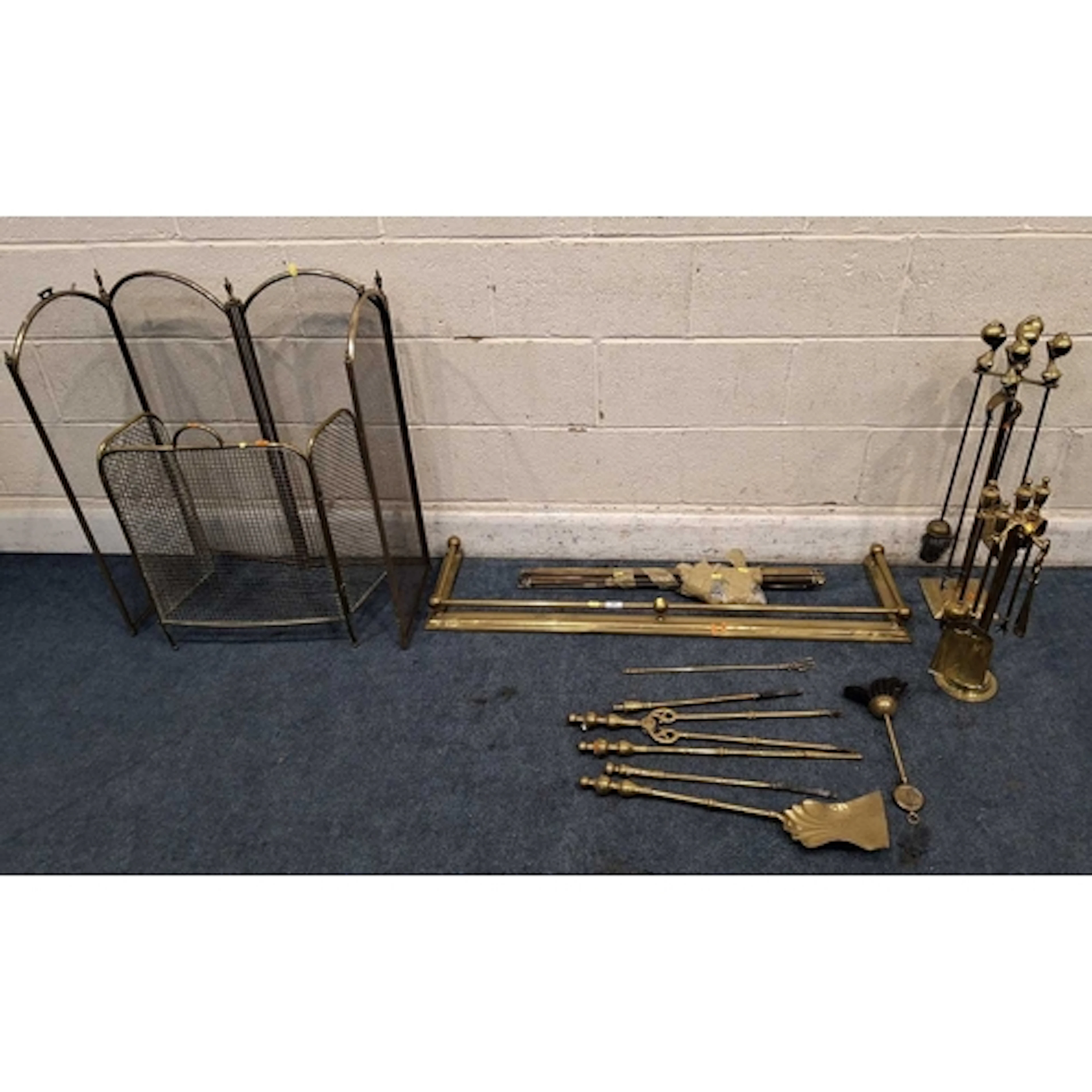 A SELECTION OF BRASS FIREPLACE ACCESSORIES, to include a fen...