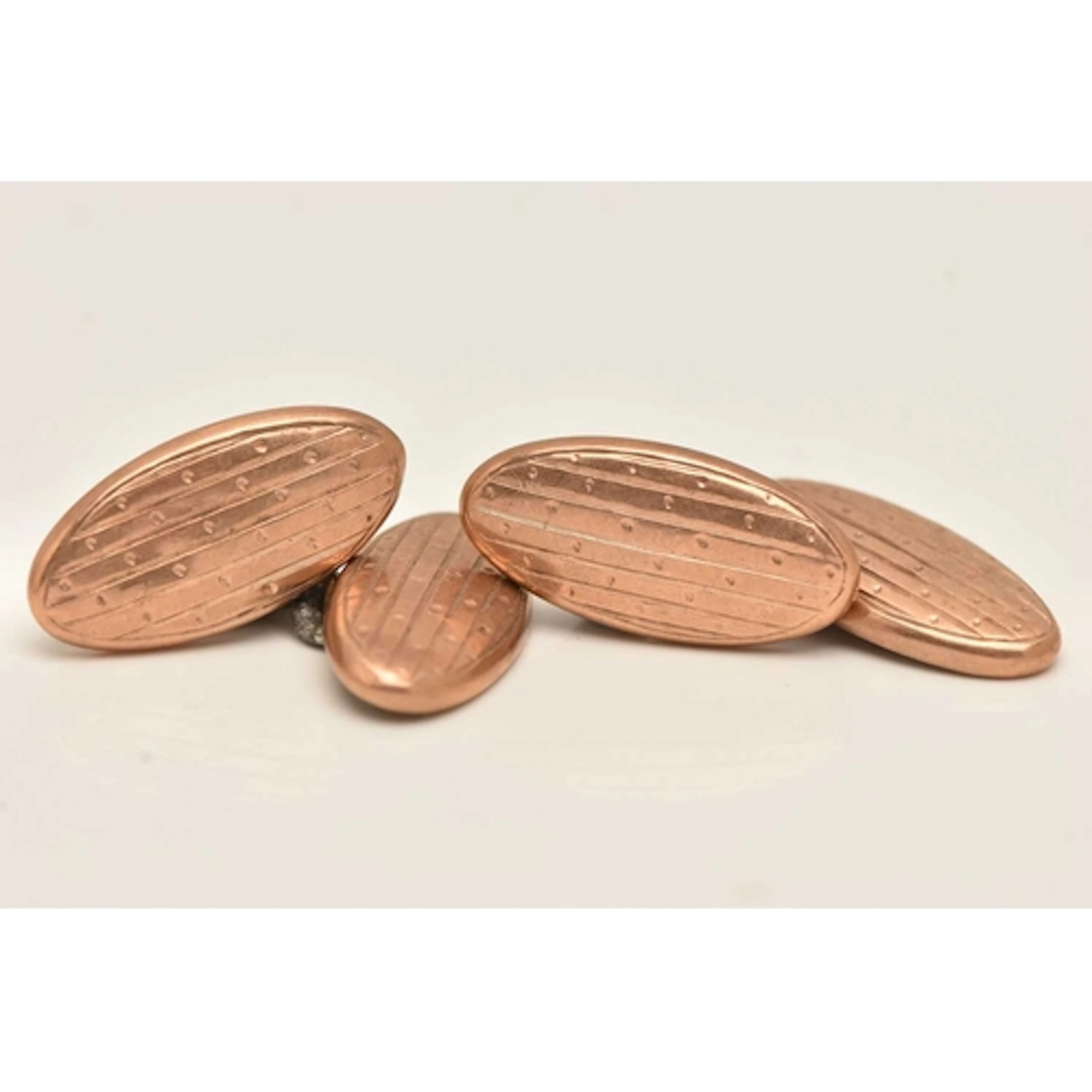 A PAIR OF 9CT ROSE GOLD CUFFLINKS, oval form patterned cuffl...