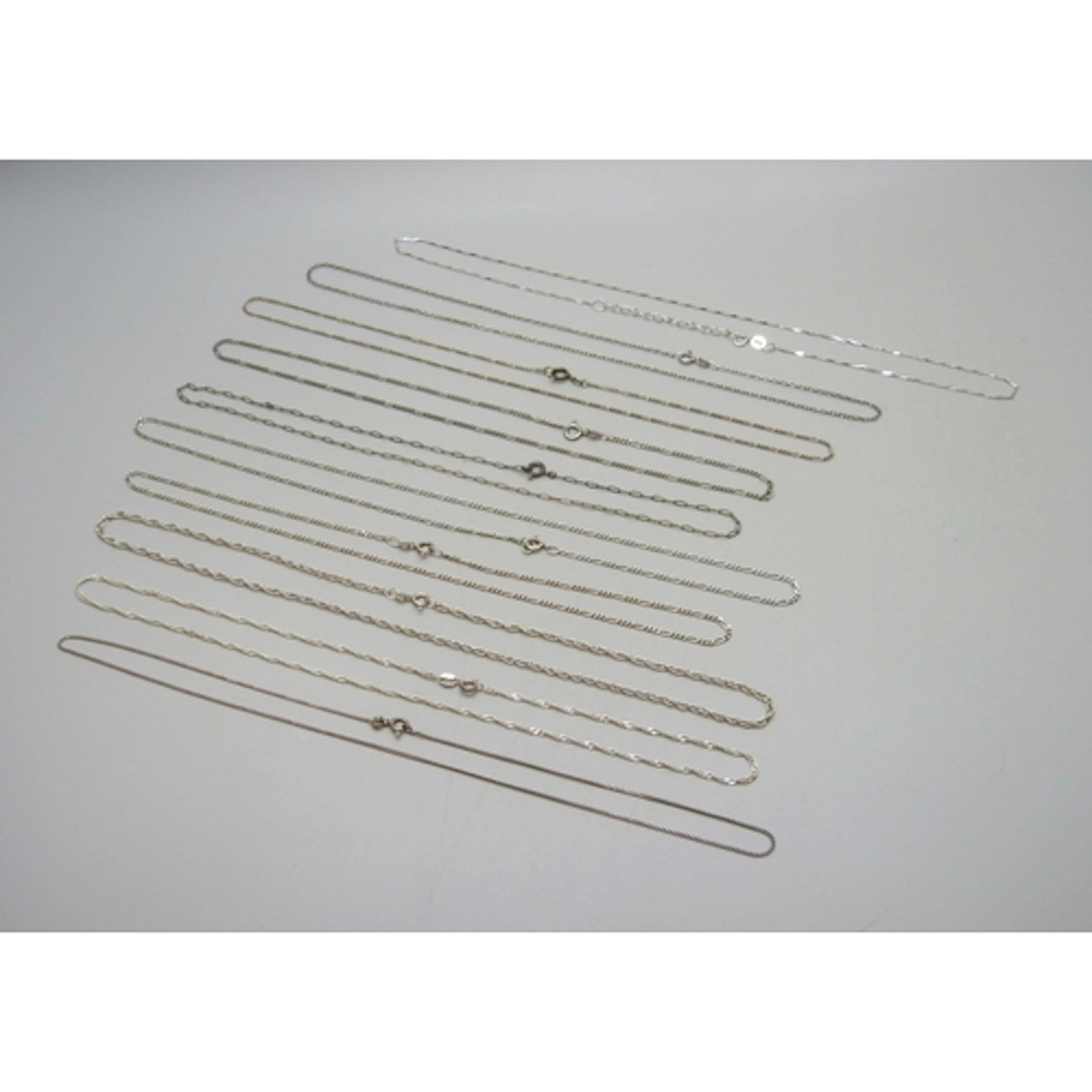 A collection of ten silver and white metal necklace chains, ...