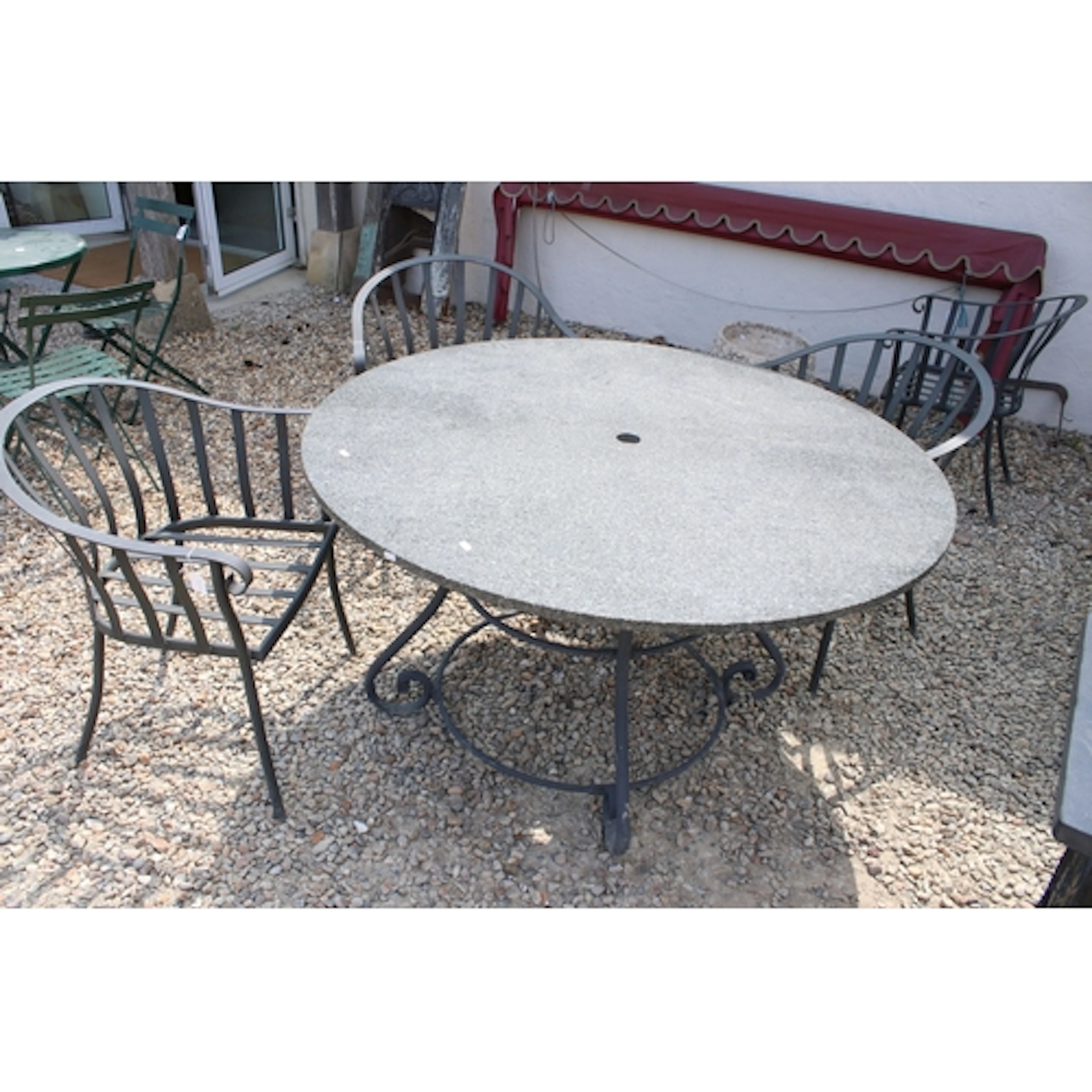Granite topped circular garden table, raised on wrought meta...