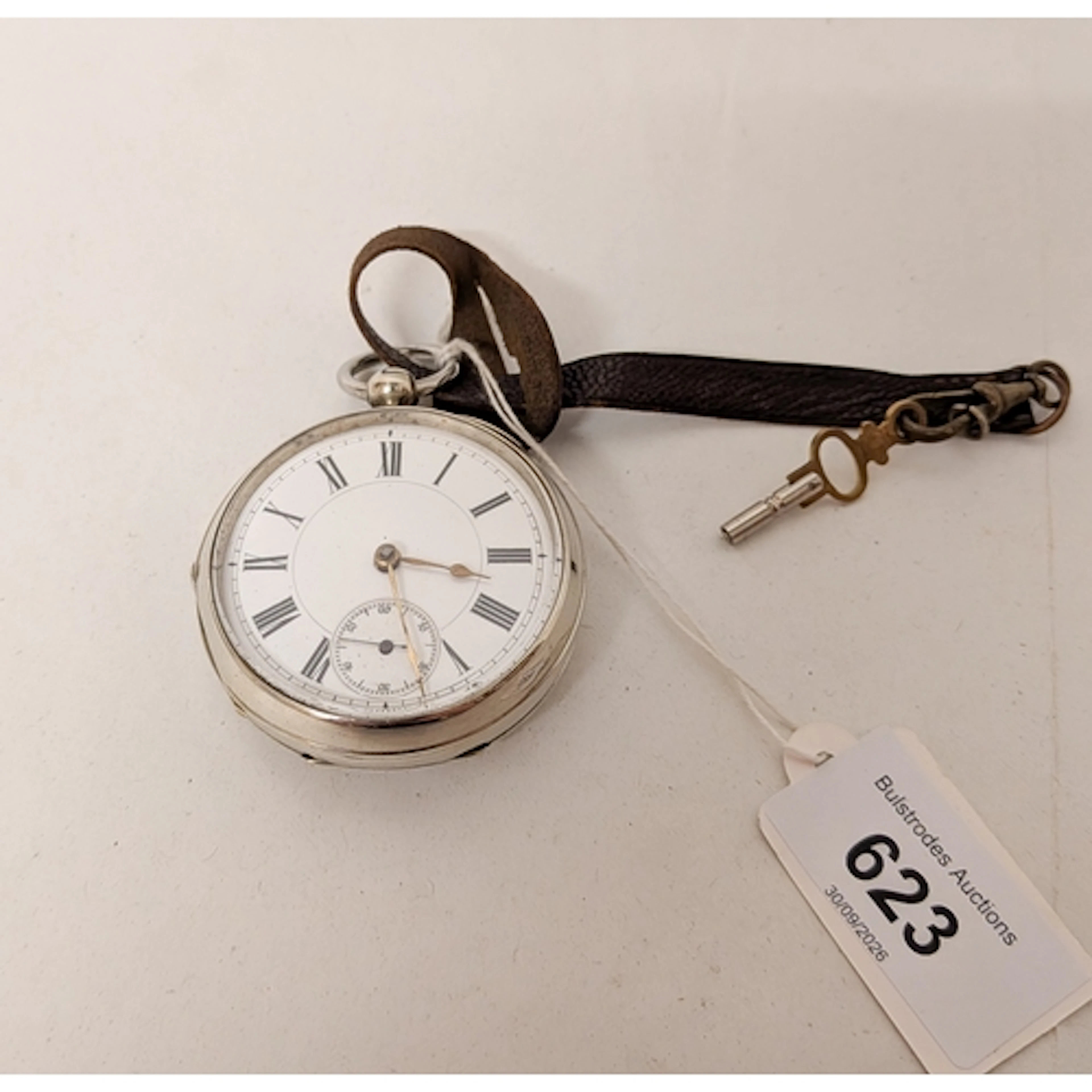 A Swiss silver plated pocket watch with key