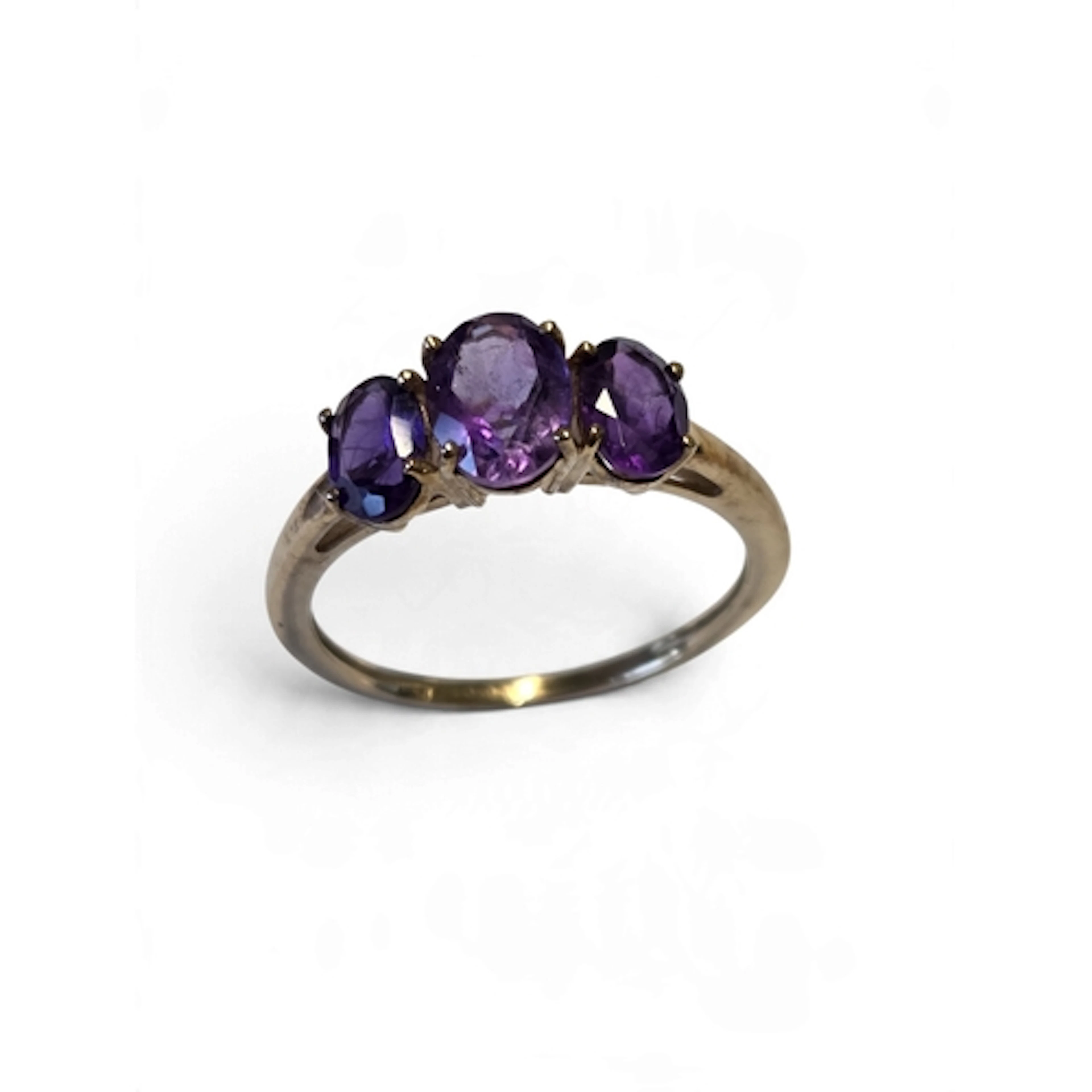 A good 9-carat gold three-stone amethyst ring, set with oval...