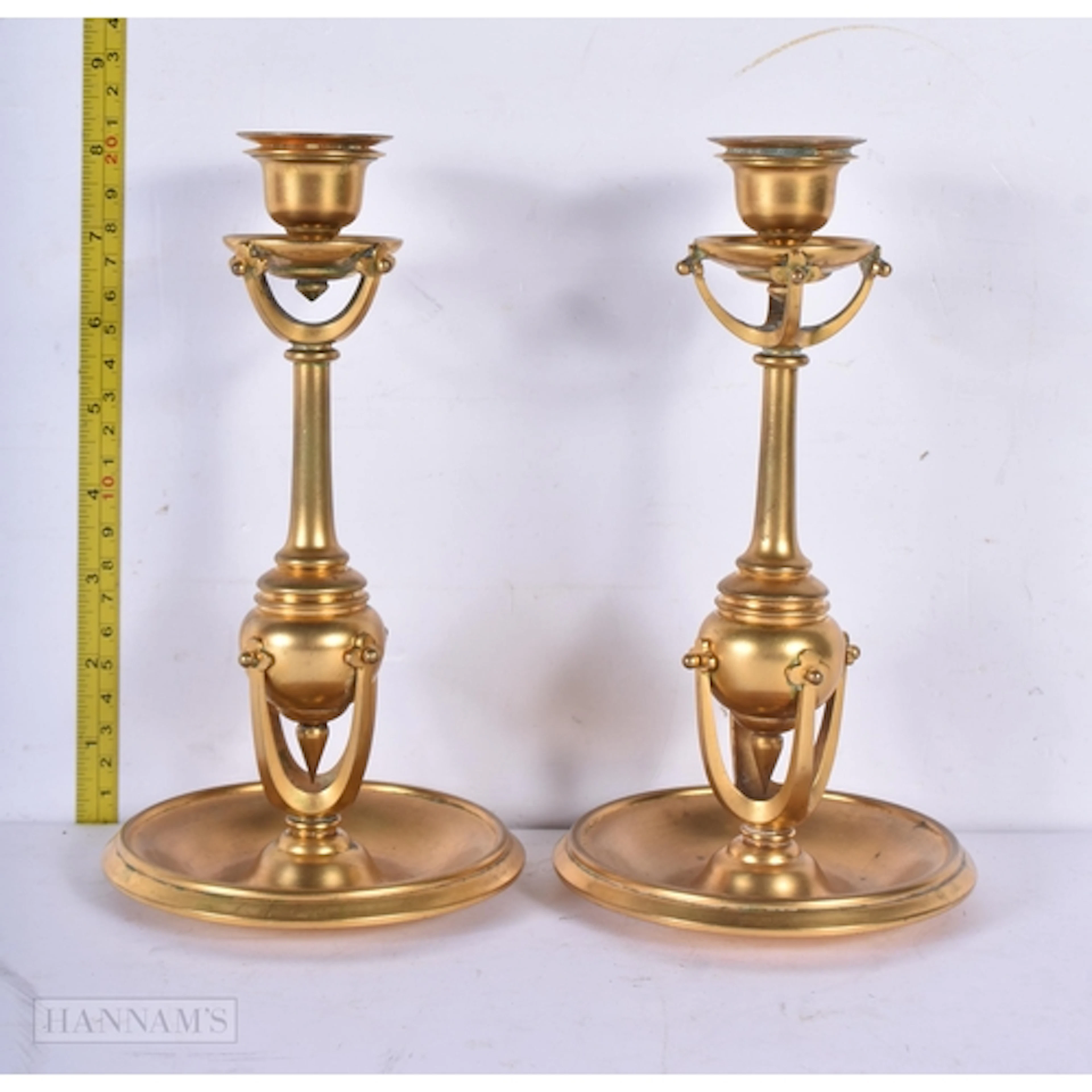 A pair of gilt metal aesthetic movement candlesticks 21cm (2...