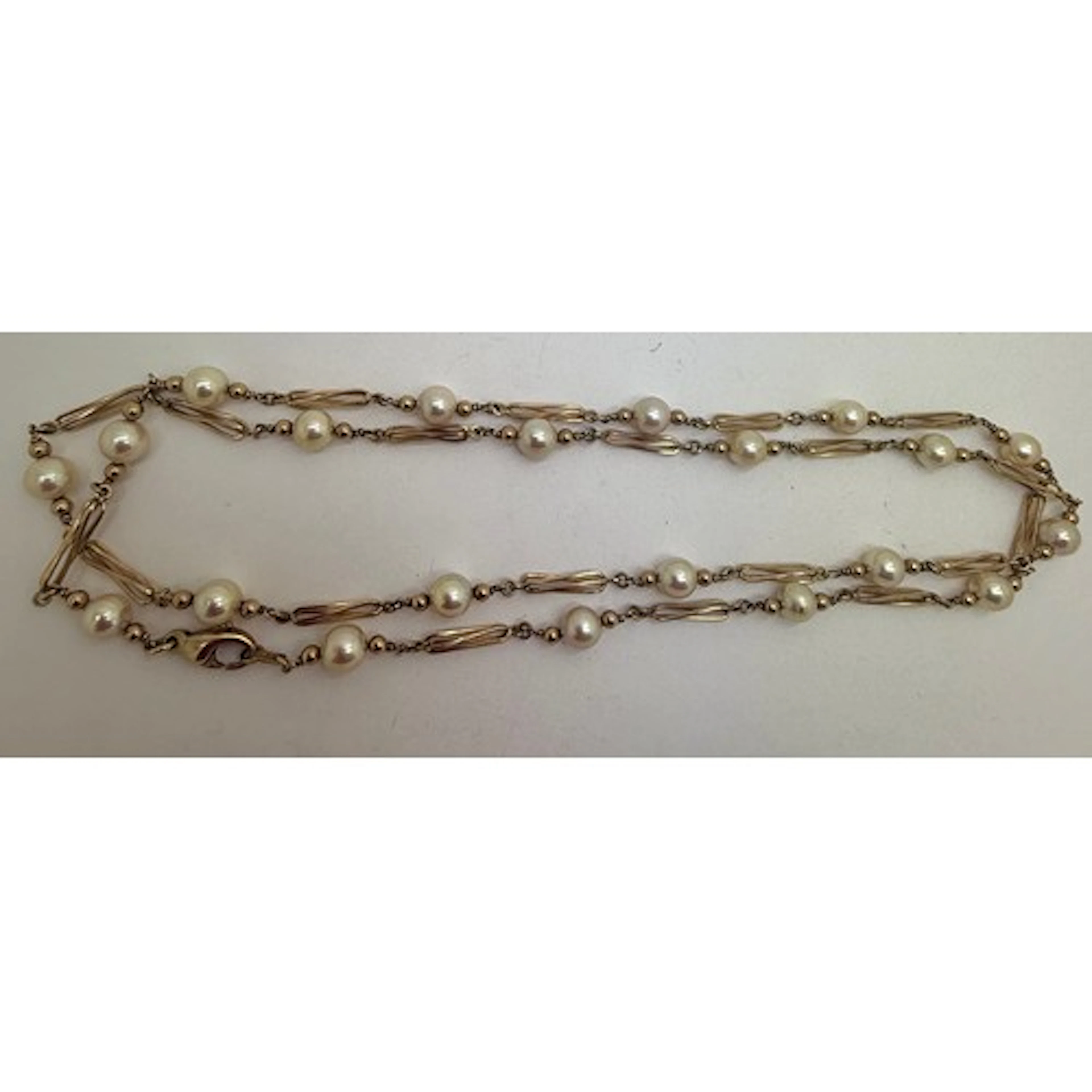 A 9 carat gold chain and cultured pearl necklace. Length 80c...