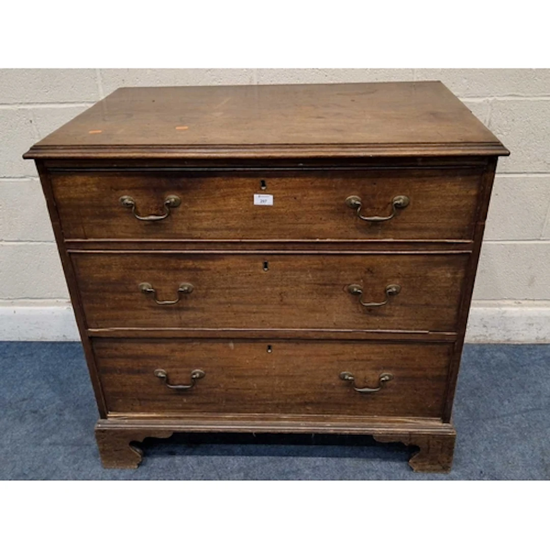 A GEORGIAN MAHOGANY CHEST OF THREE GRADUATED DRAWERS, raised...