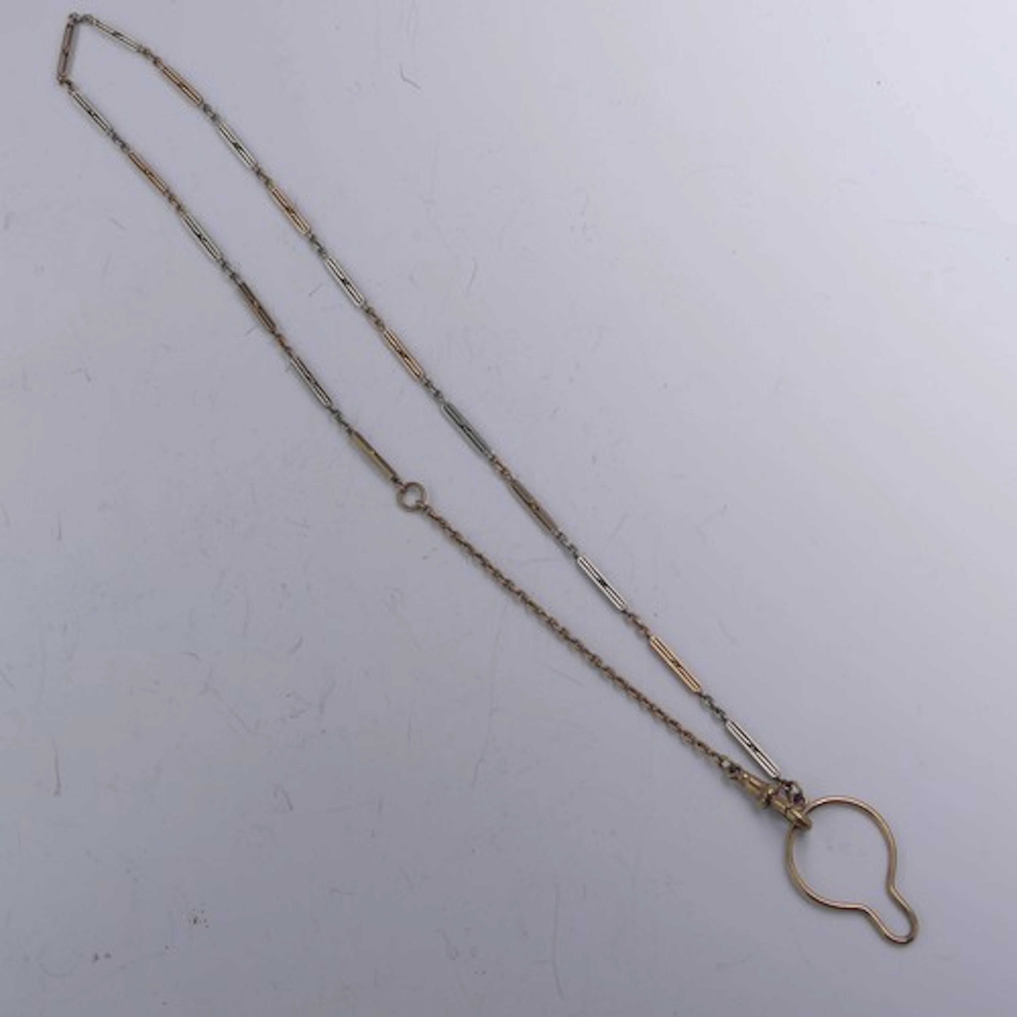 A 9ct yellow and white gold Watch Chain, one end with button...
