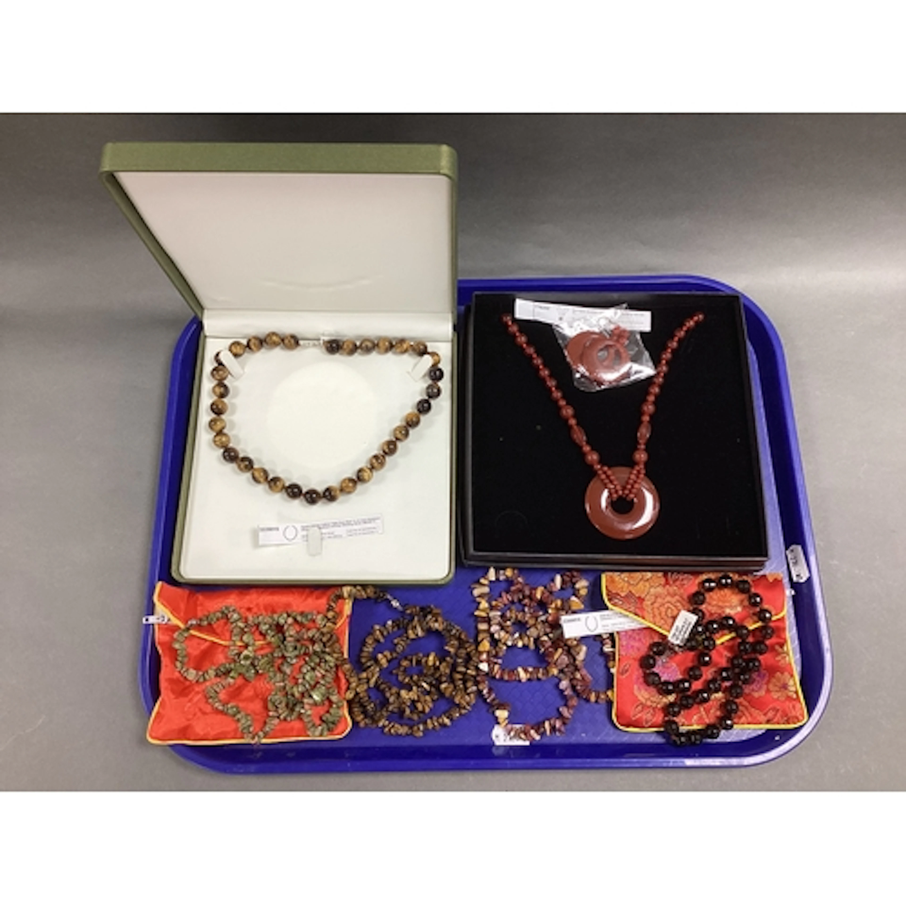 A Collection of Modern Polished Hardstone Jewellery, in hues...
