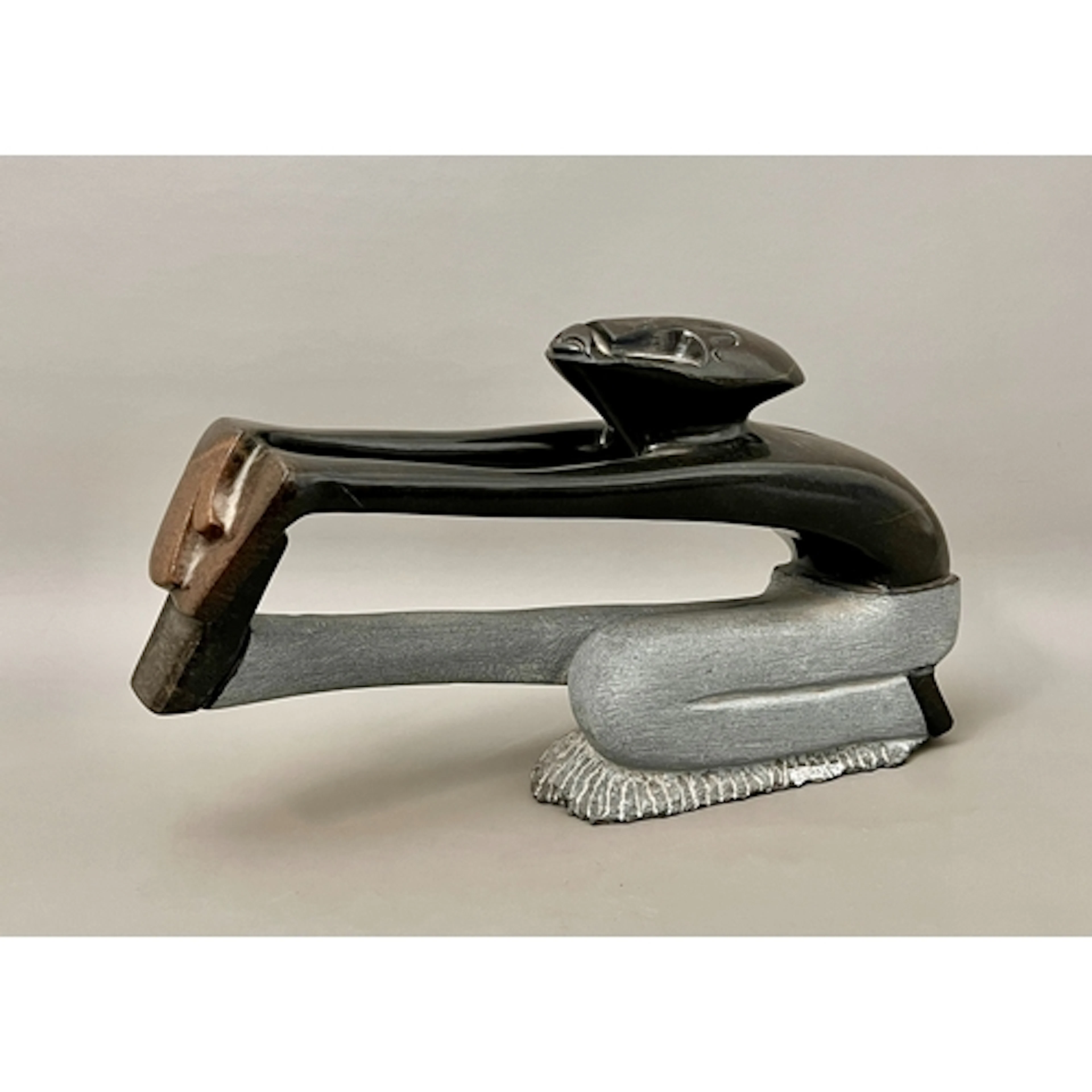 A modern Shona carved stone sculpture of a man stretching - ...
