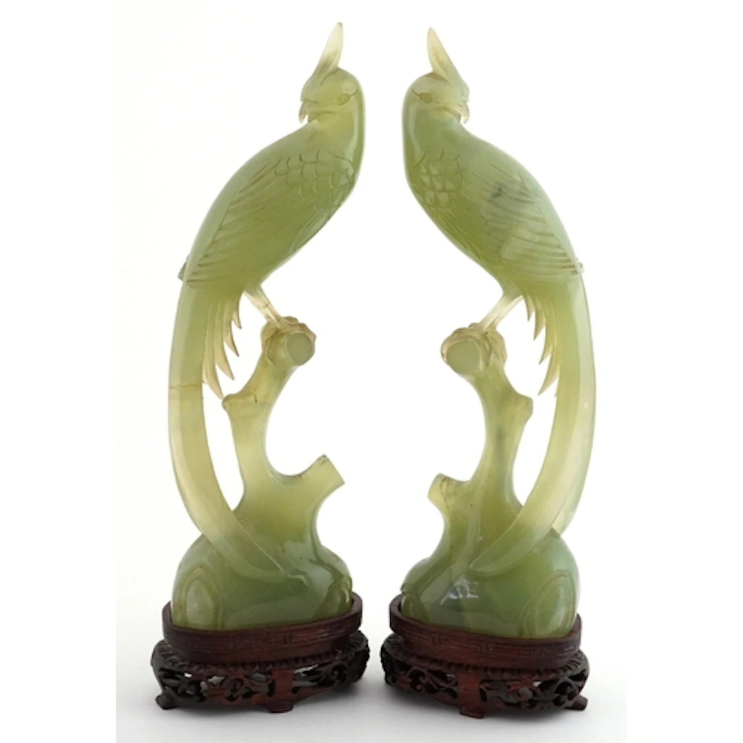 Pair of Chinese carved green stone studies of birds of parad...